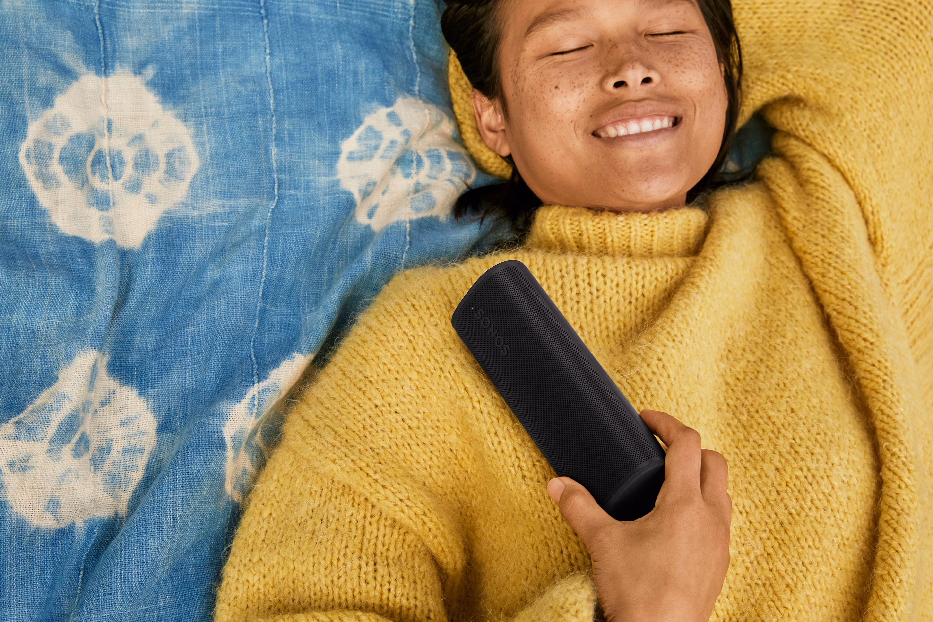 Person smiling and holding Roam 2 black