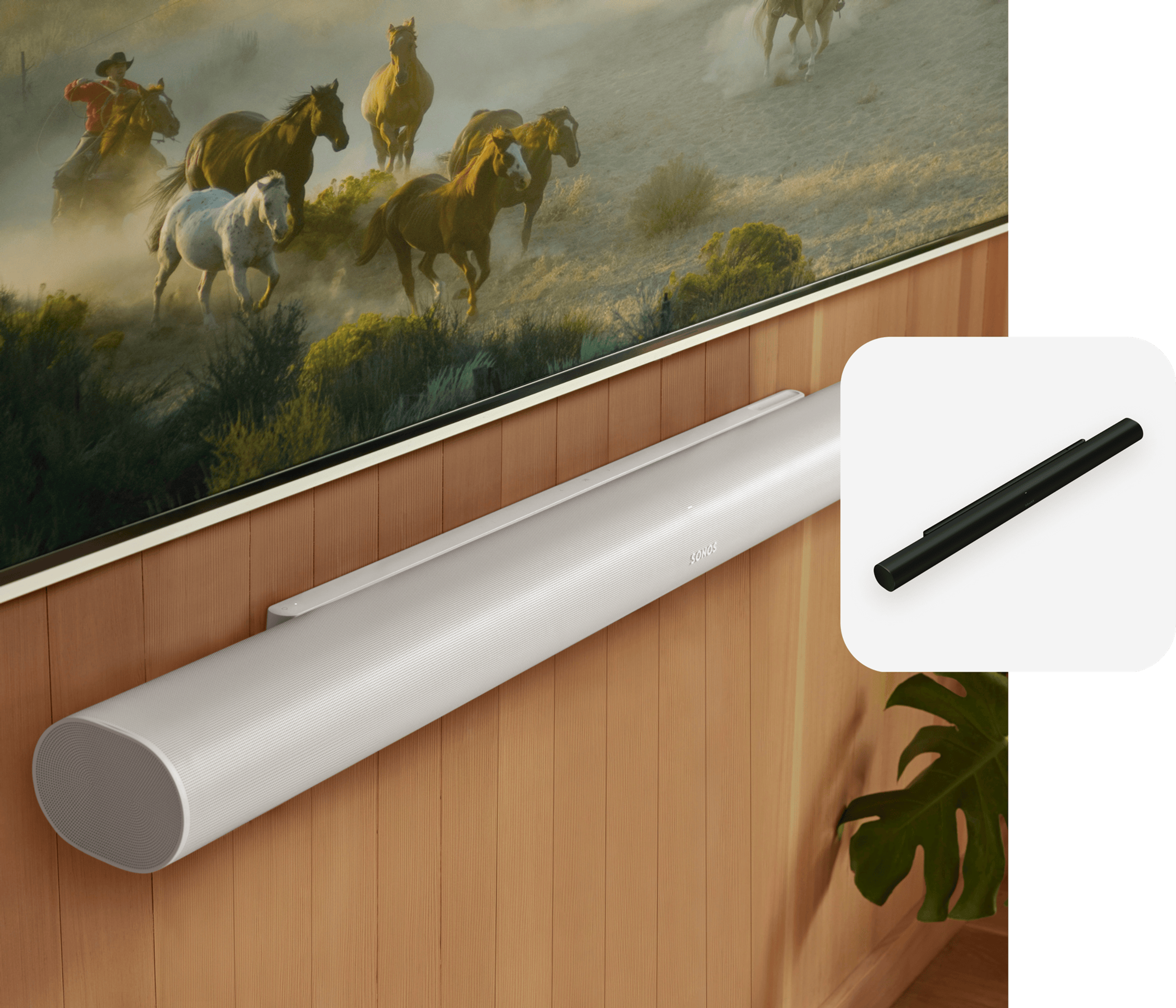 Closeup of a white Arc Ultra mounted to a wood-panelled wall below a TV and a black Arc Ultra product tile overlay