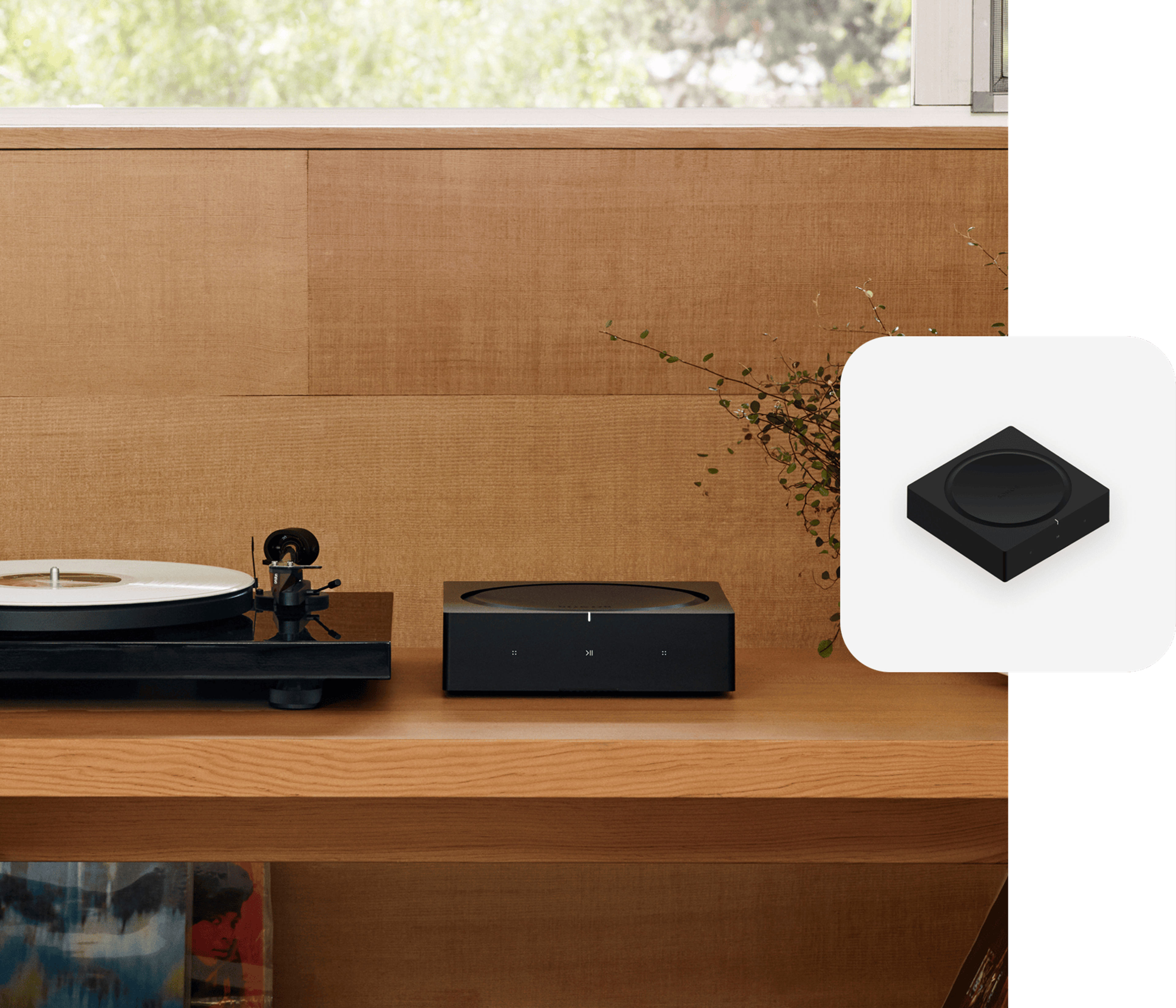 Sonos Amp sitting on a shelf next to a record player