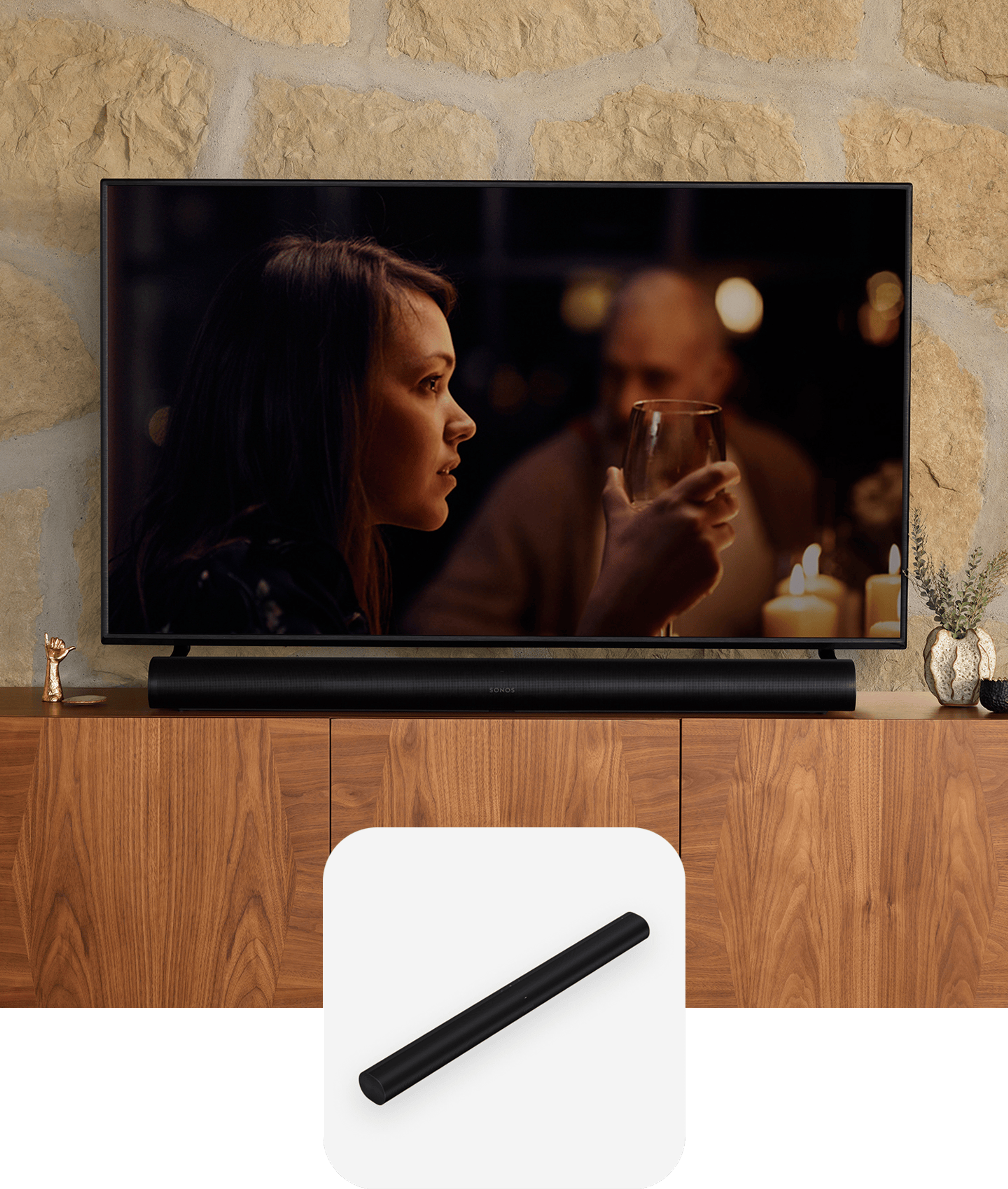 A black Sonos Arc soundbar sitting on a media console below a TV