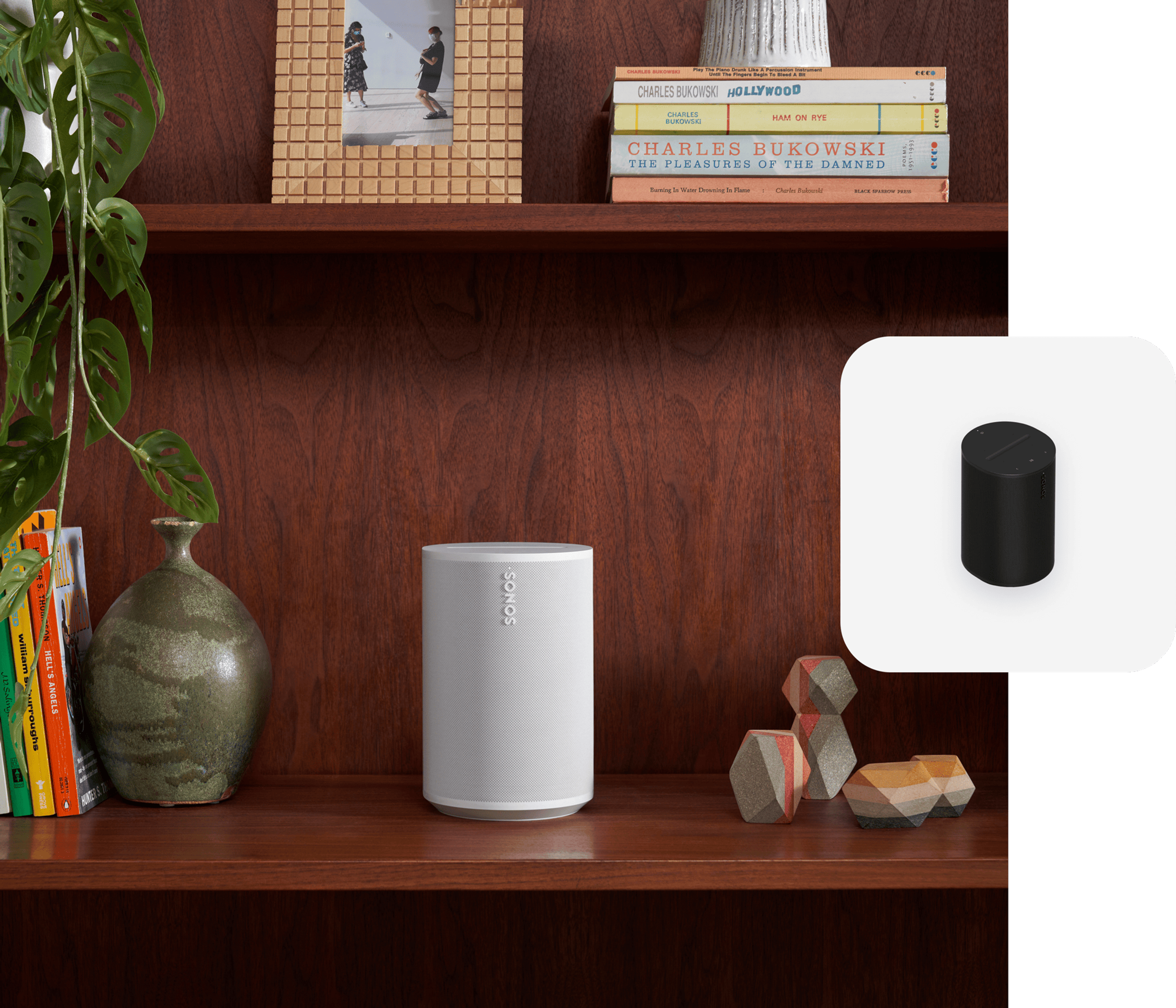 White Sonos Era 100 on a bookshelf with black Era 100 product tile overlay