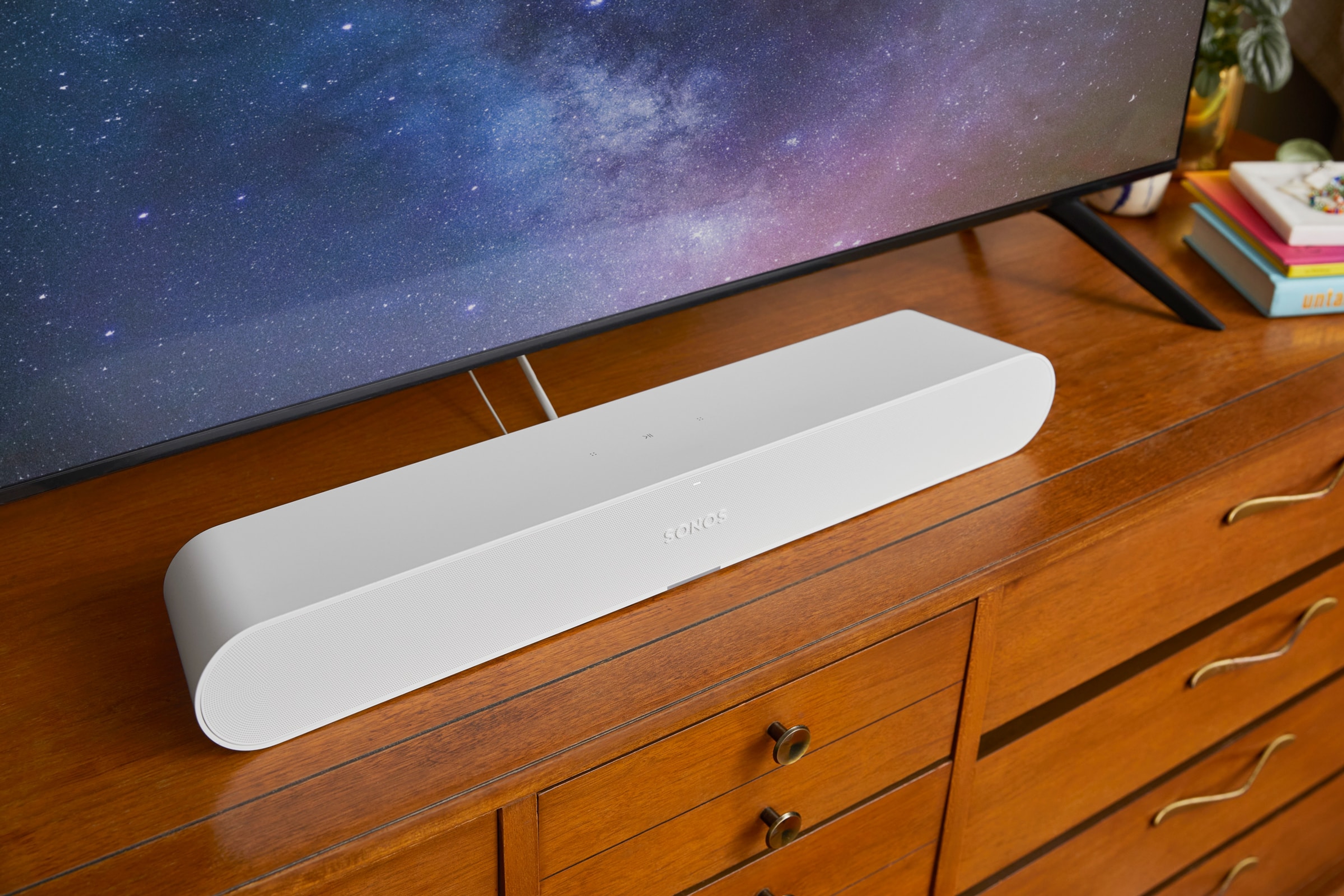 White Sonos Ray on top of a TV stand