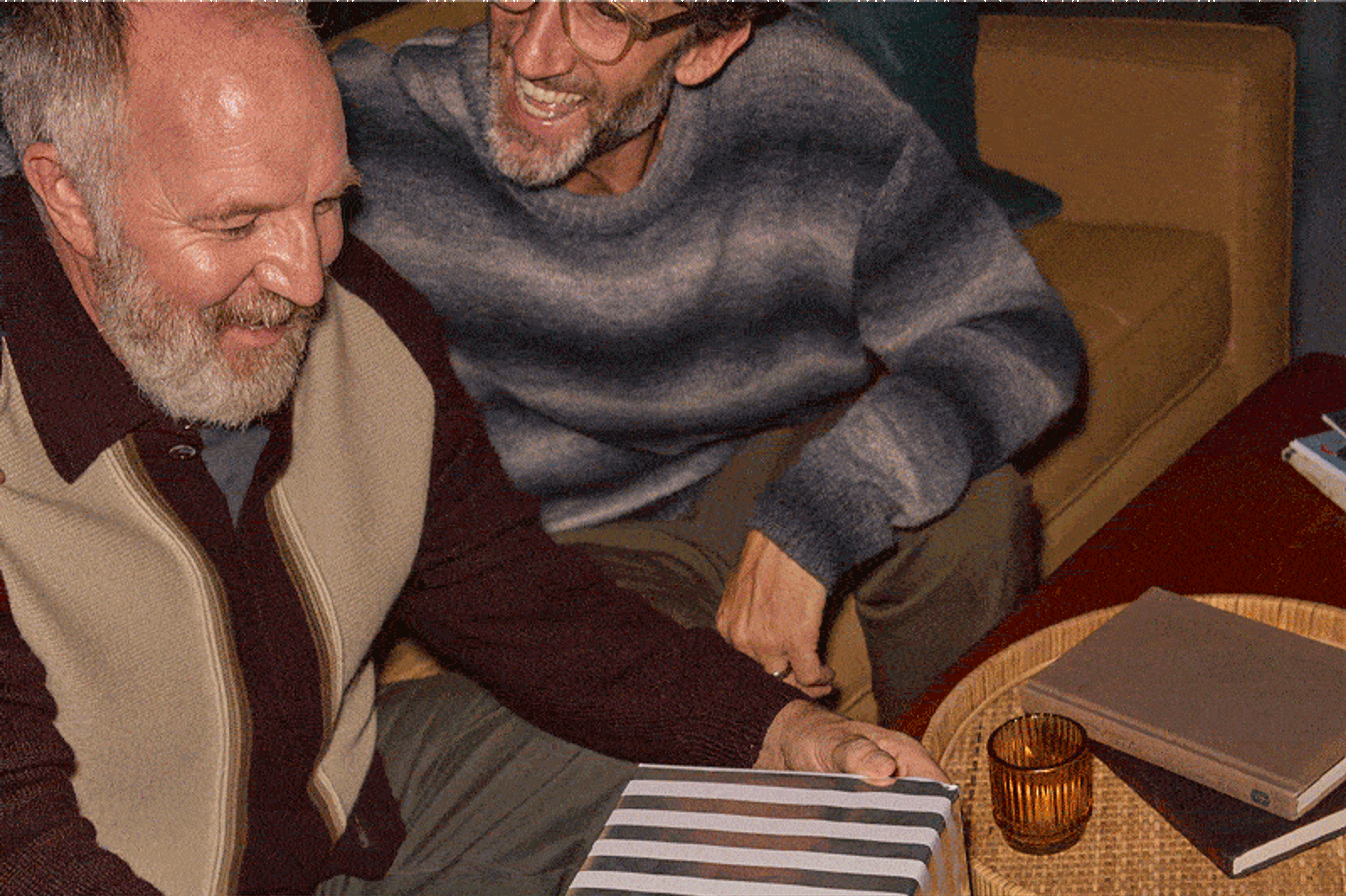 A dad unwrapping a holiday gift of Sonos Move 2 from his son