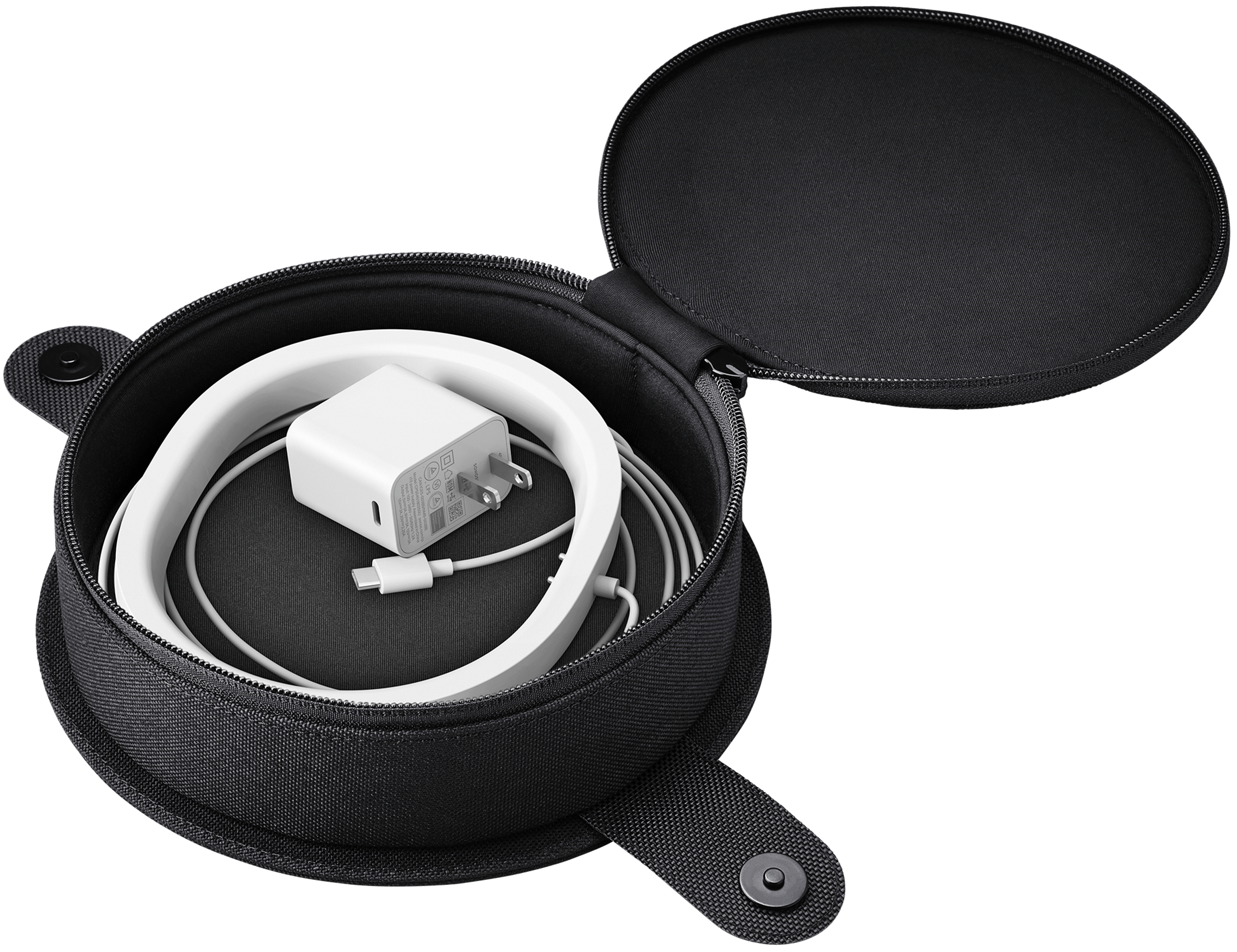 Image of the open charging base compartment of the Move Travel Bag with a white Move charging base inside