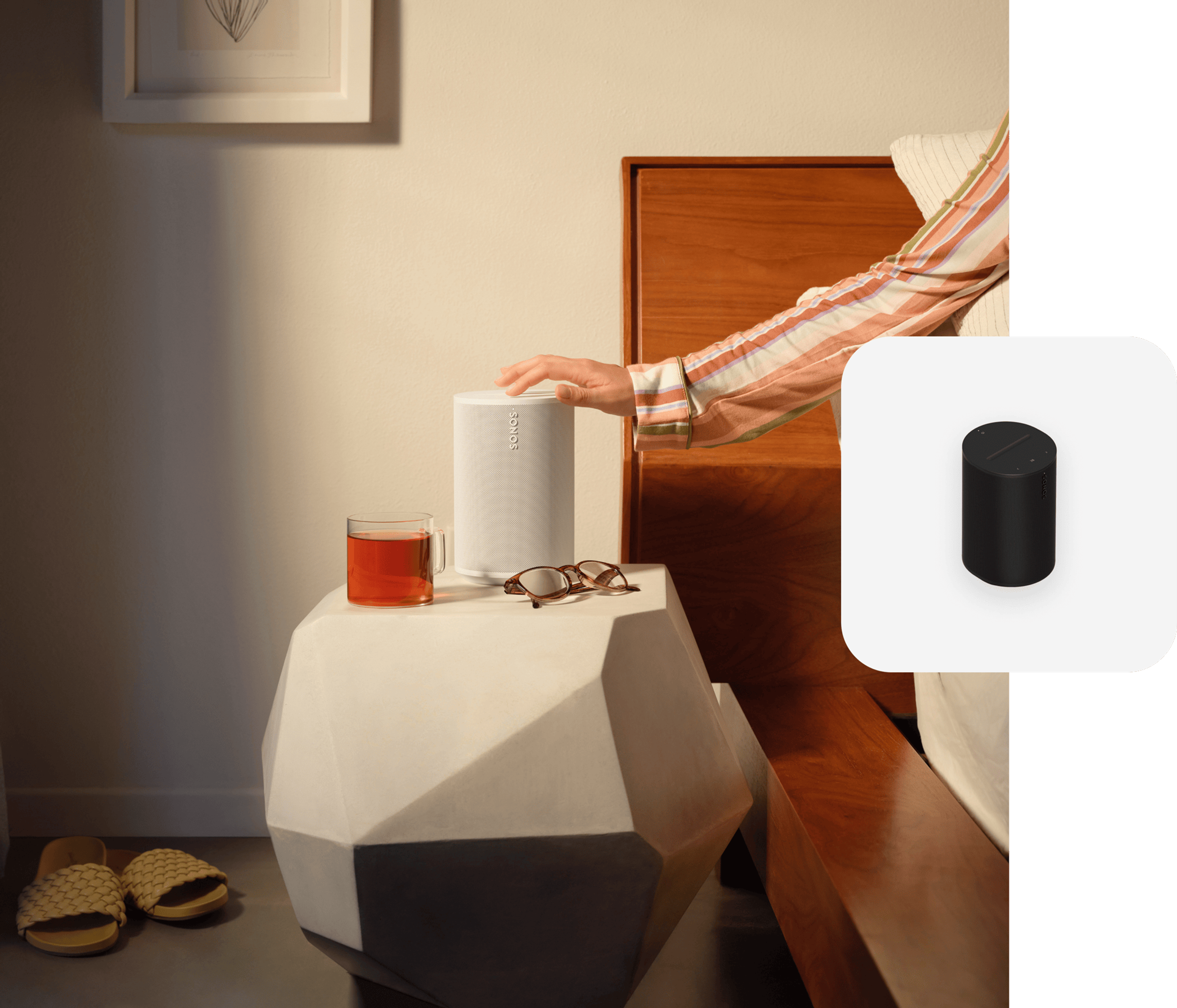 Hand touching a white Era 100 on a bedside table with black Era 100 product tile overlay