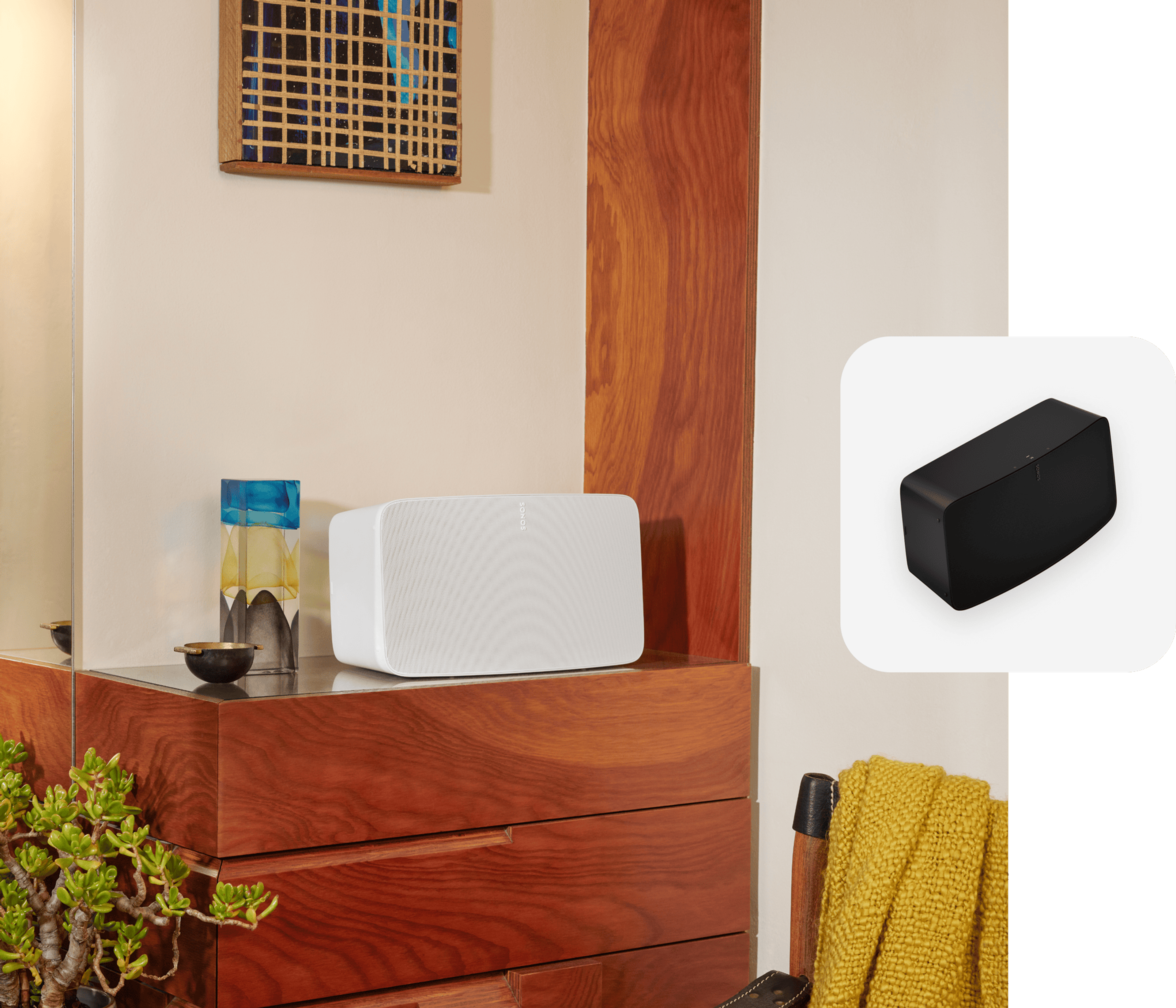A white Sonos Five speaker sitting on a bedroom dresser