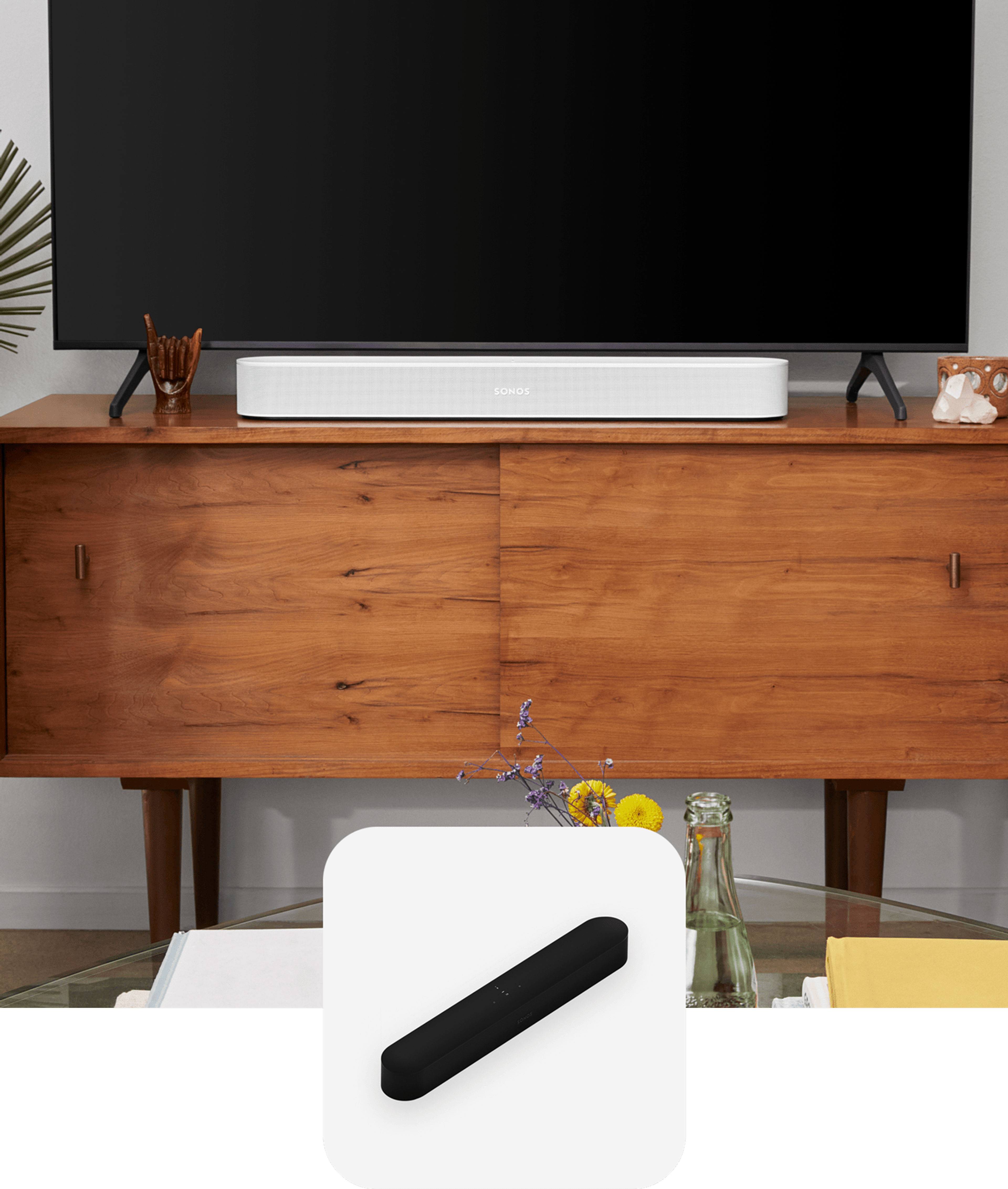 A white Sonos Beam soundbar on a media console below a TV
