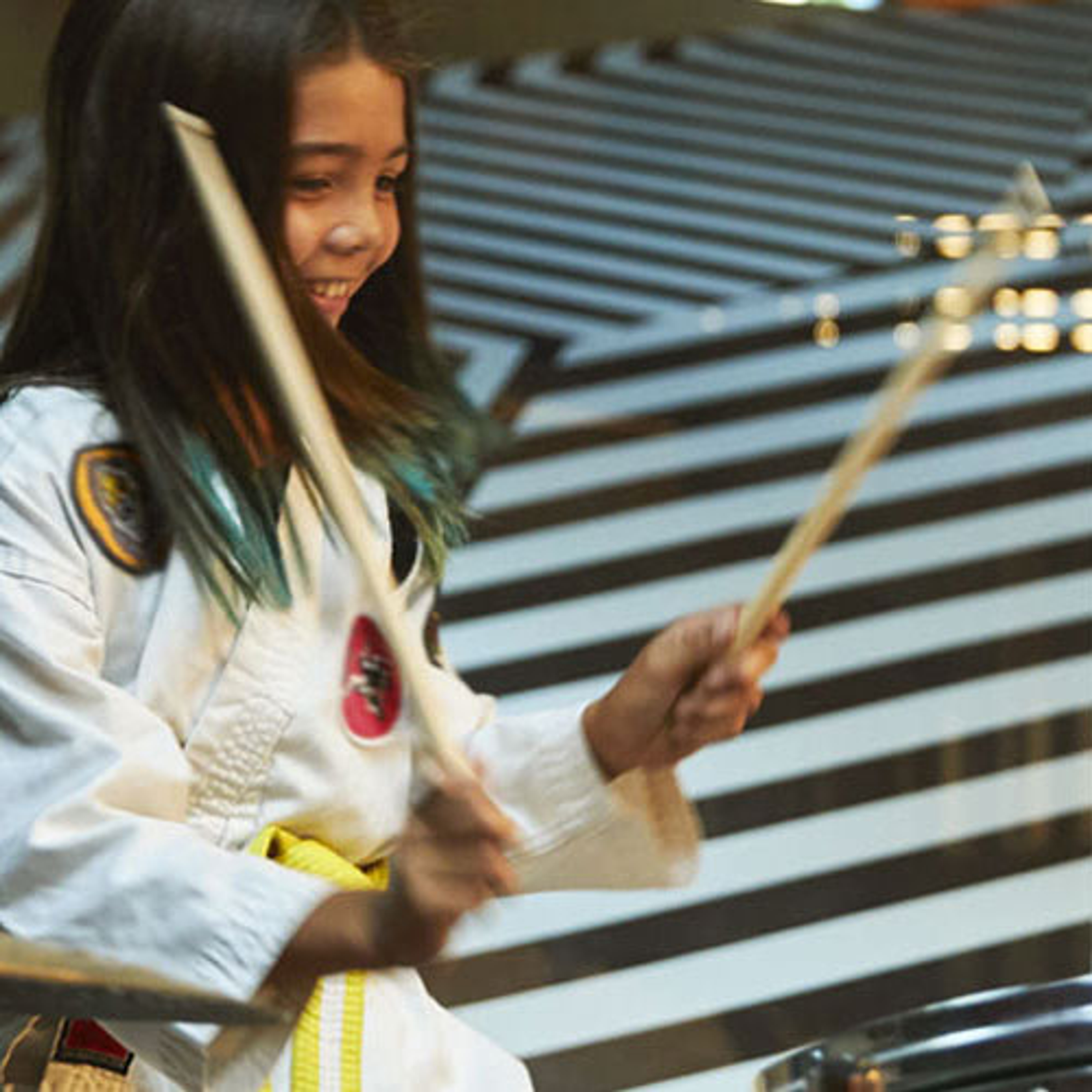 A kid playing drums