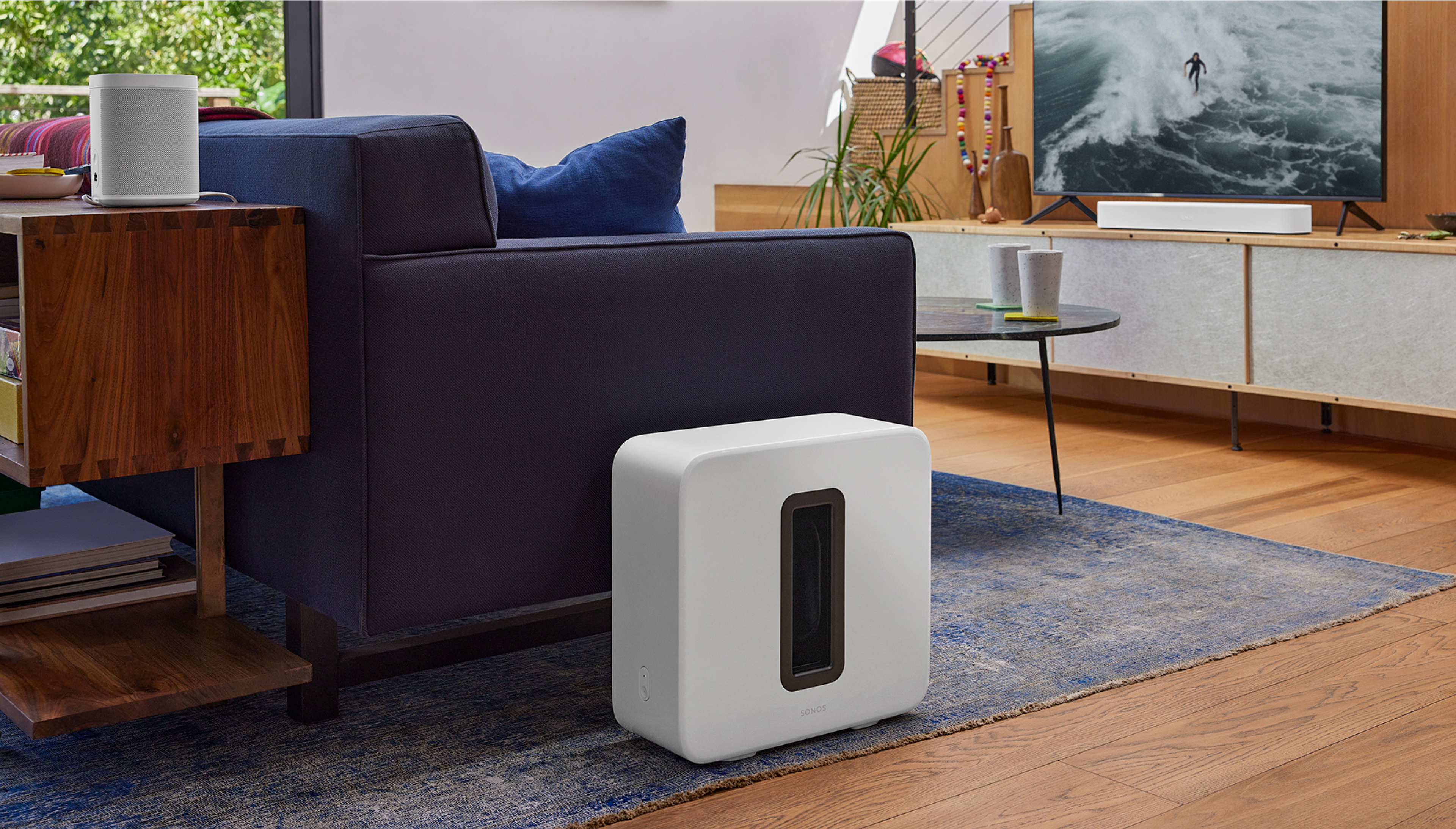 Home theatre setup with white Beam, Sub, and One SL