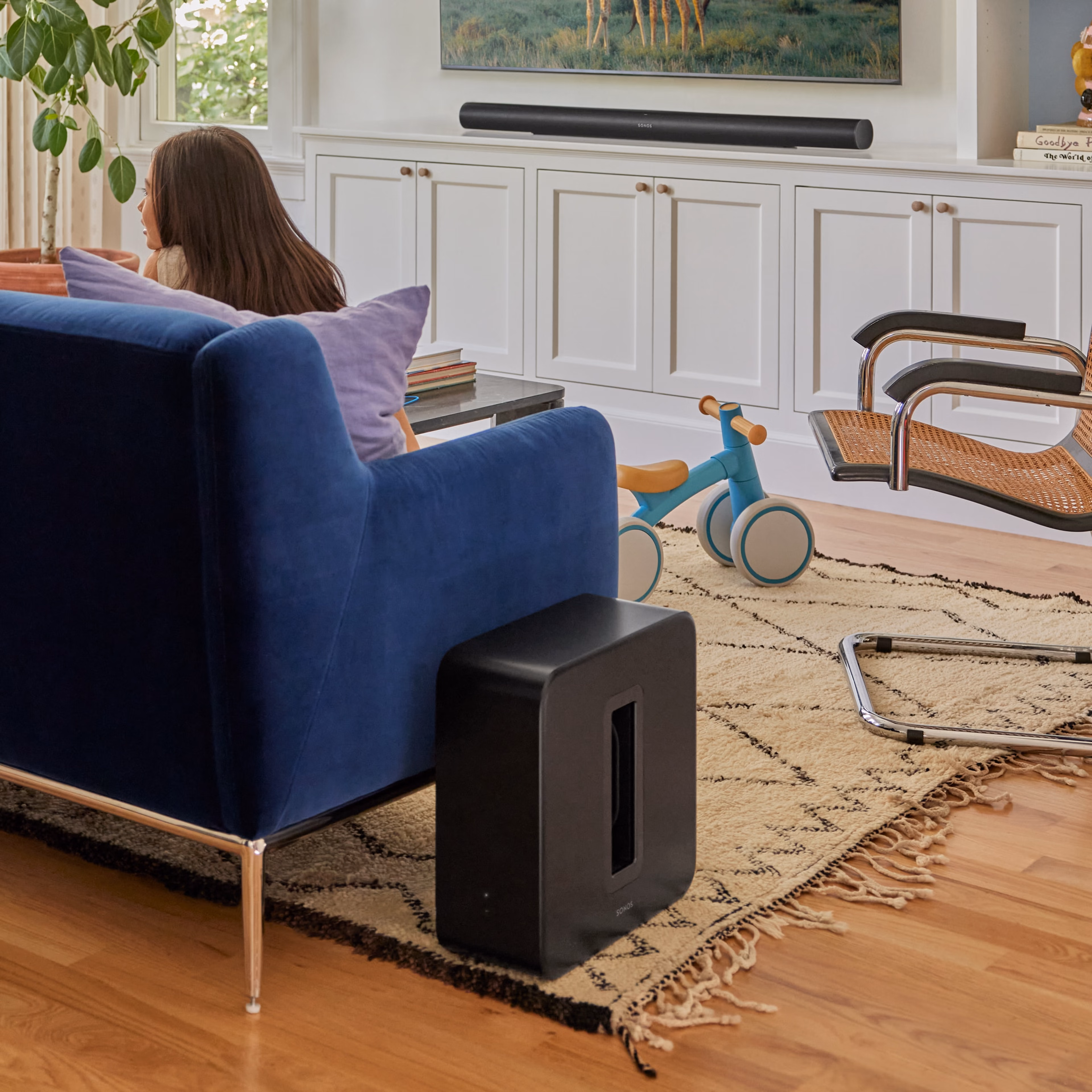 A Sub 4 next to a couch in a living room, being used with an Arc Ultra
