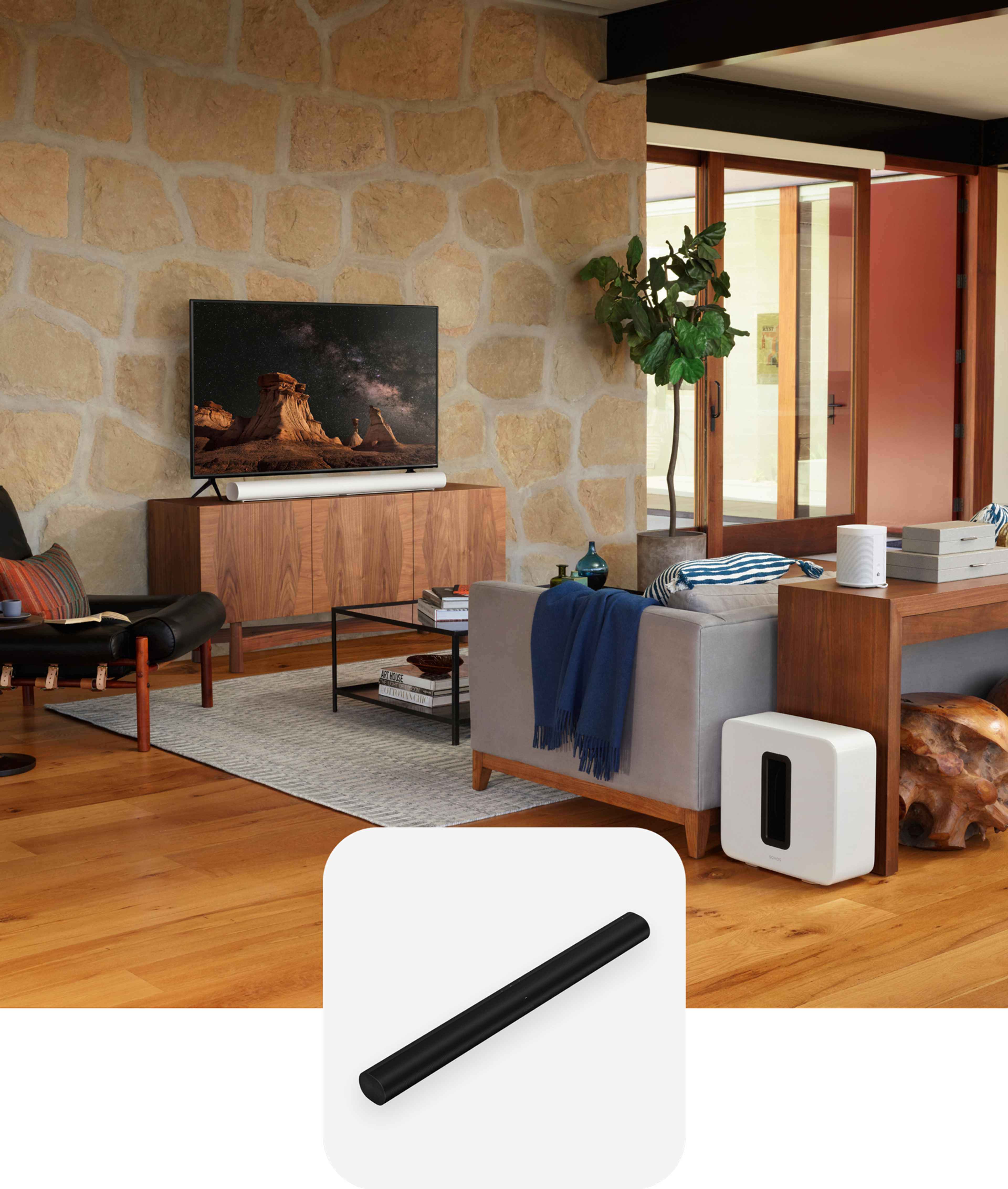 A home theatre setup in a living room featuring white Sonos Arc, Sub, and two Era 100 speakers