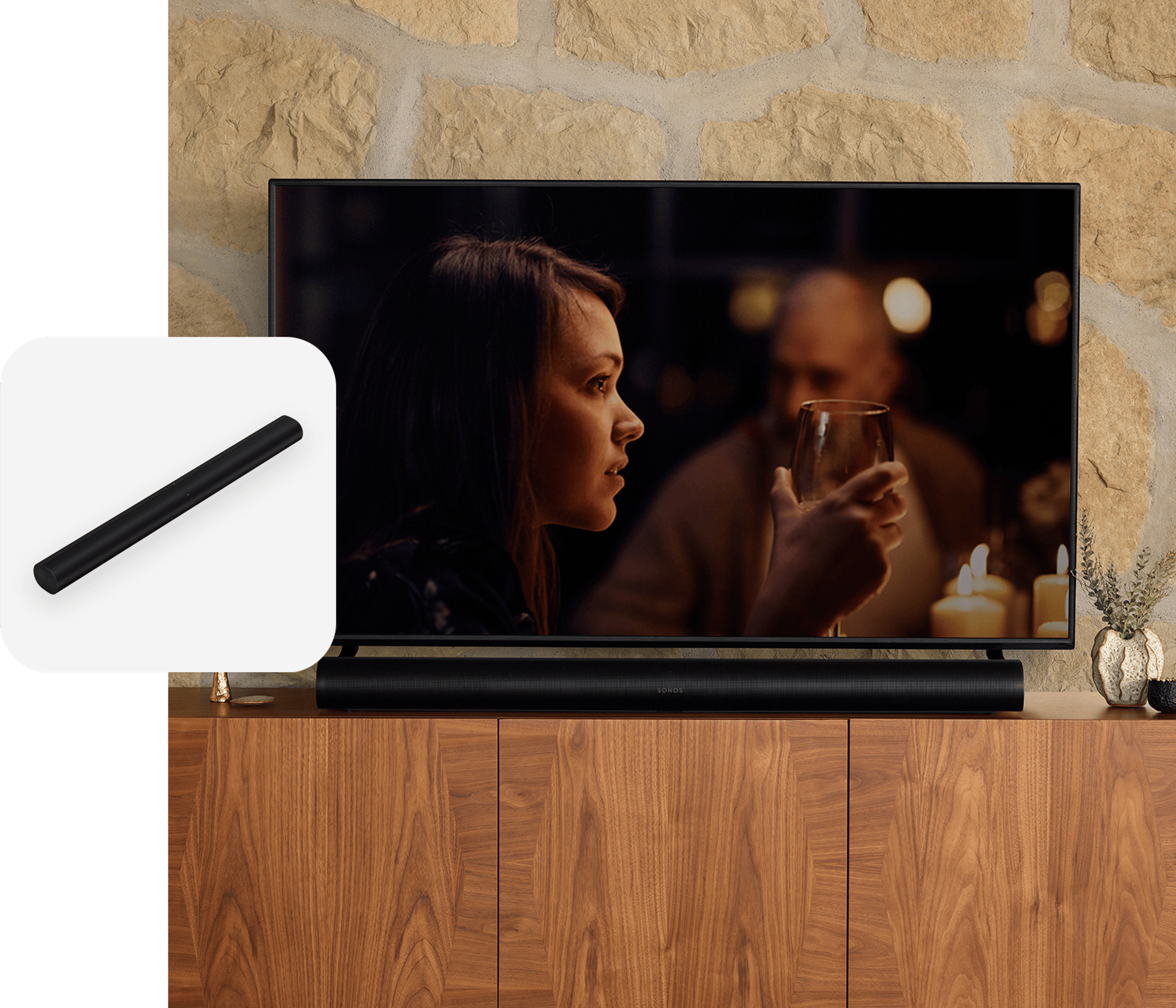 A black Sonos Arc soundbar sitting on a media console below a TV