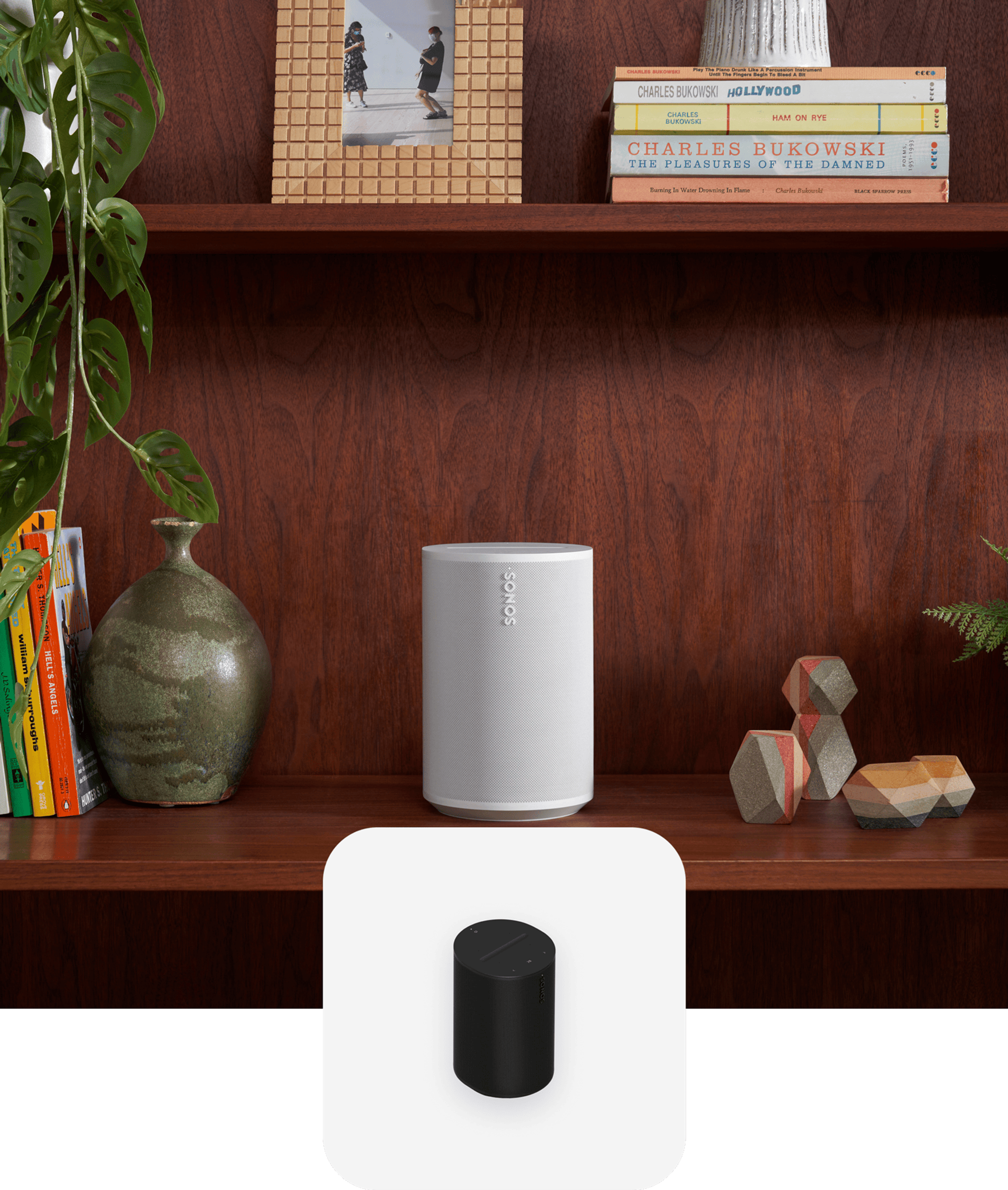 White Sonos Era 100 on a bookshelf with black Era 100 product tile overlay
