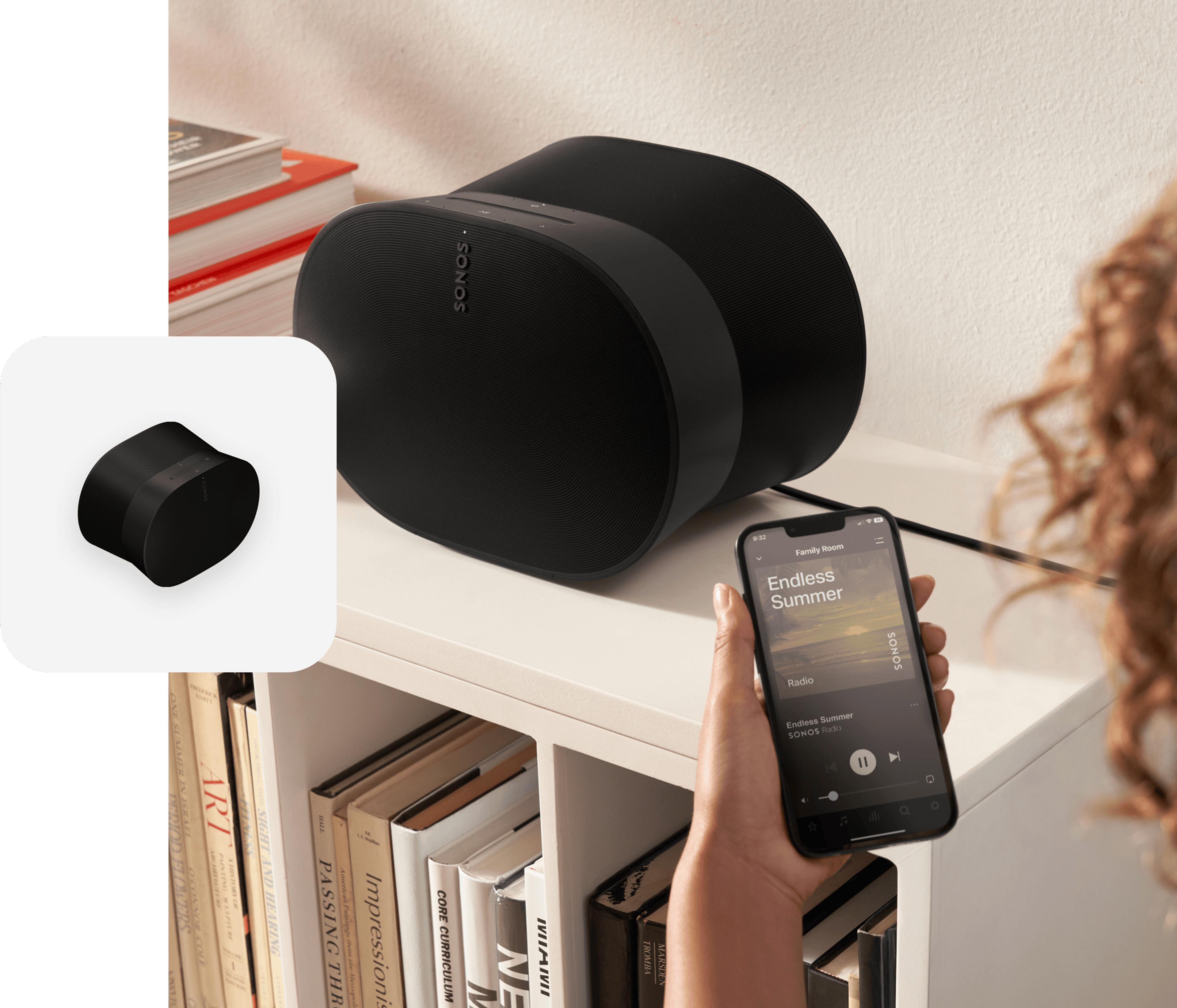 User with phone using the Sonos App to control a black Era 300 speaker