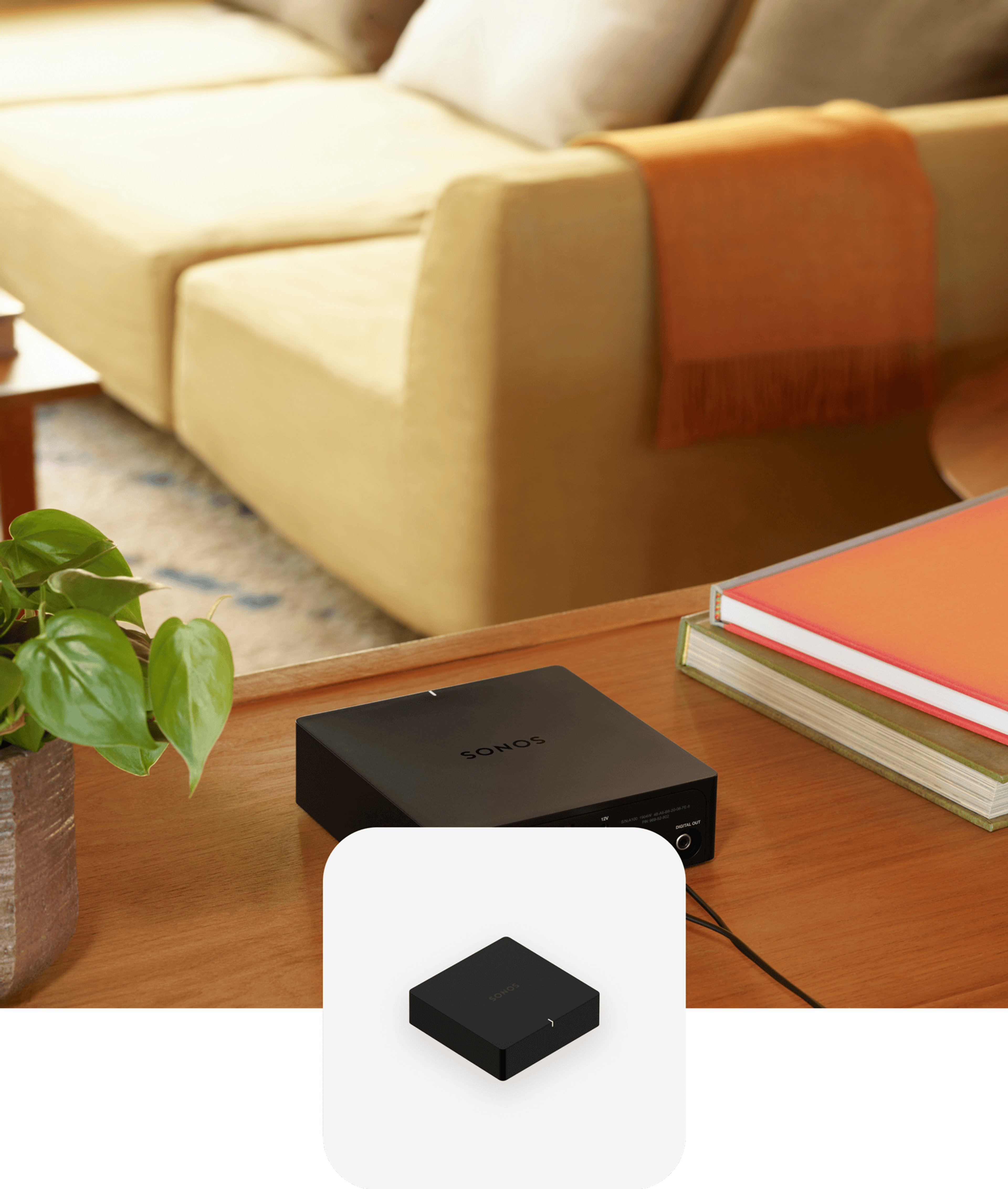 Black Sonos Port on a console table next to books with a black Port product tile overlay