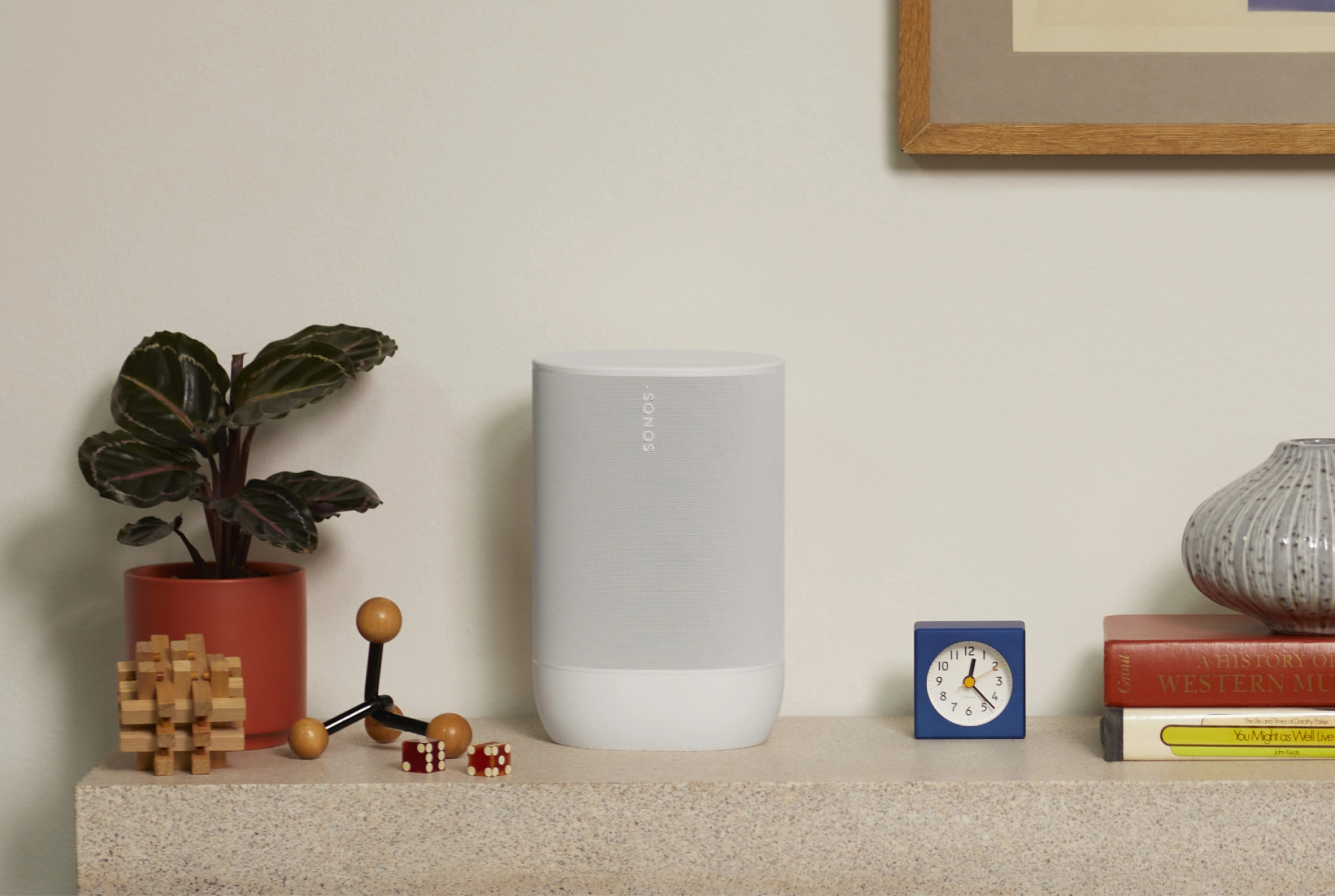 Image of a white Sonos Move 2 on a sideboard next to a plant