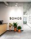 Sonos sign above plants at front reception desk of Sonos office