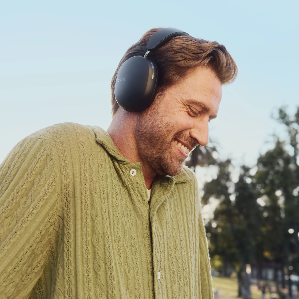 Person wearing black Sonos Ace headphones
