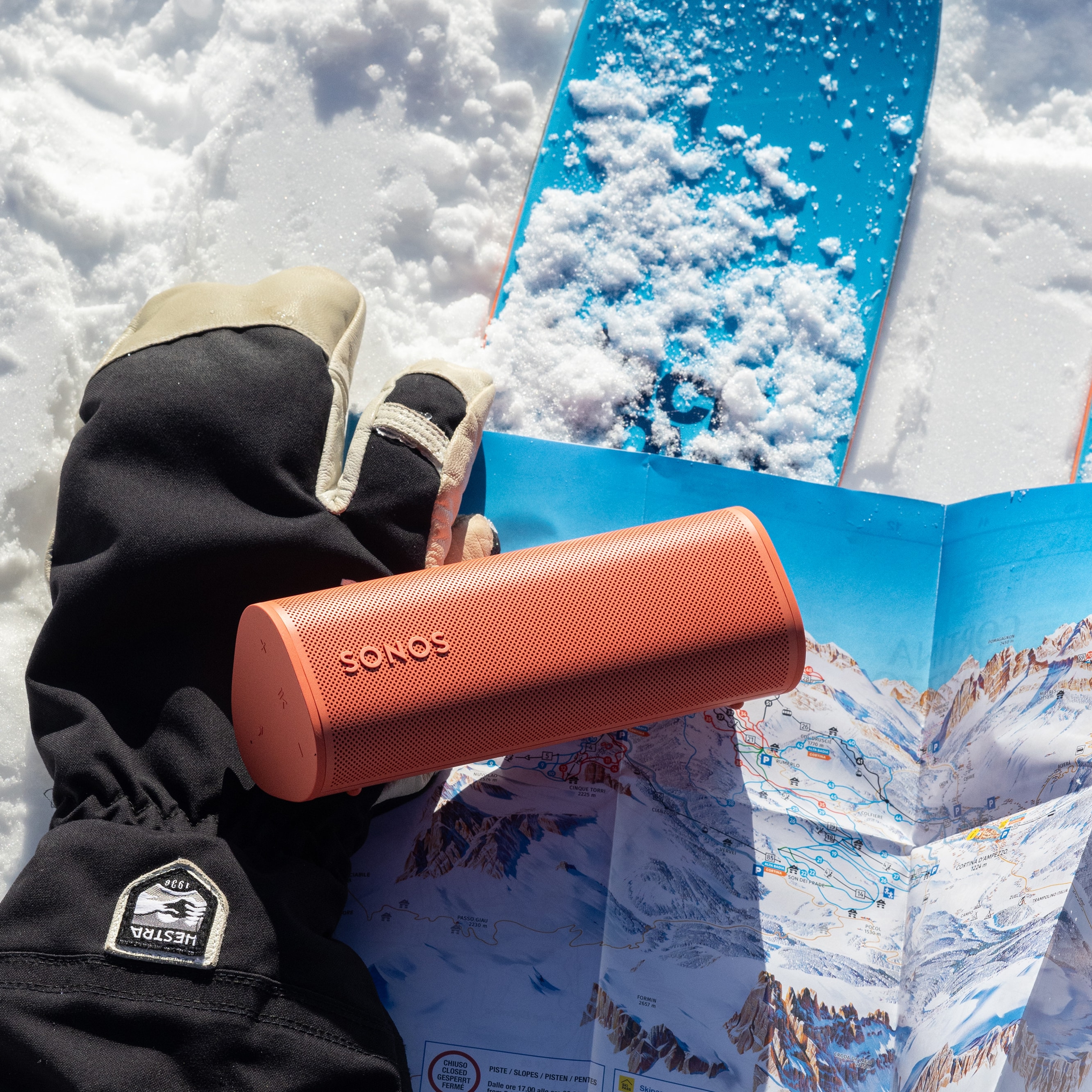 Roam 2 Sunset on a glove and skis in the snow