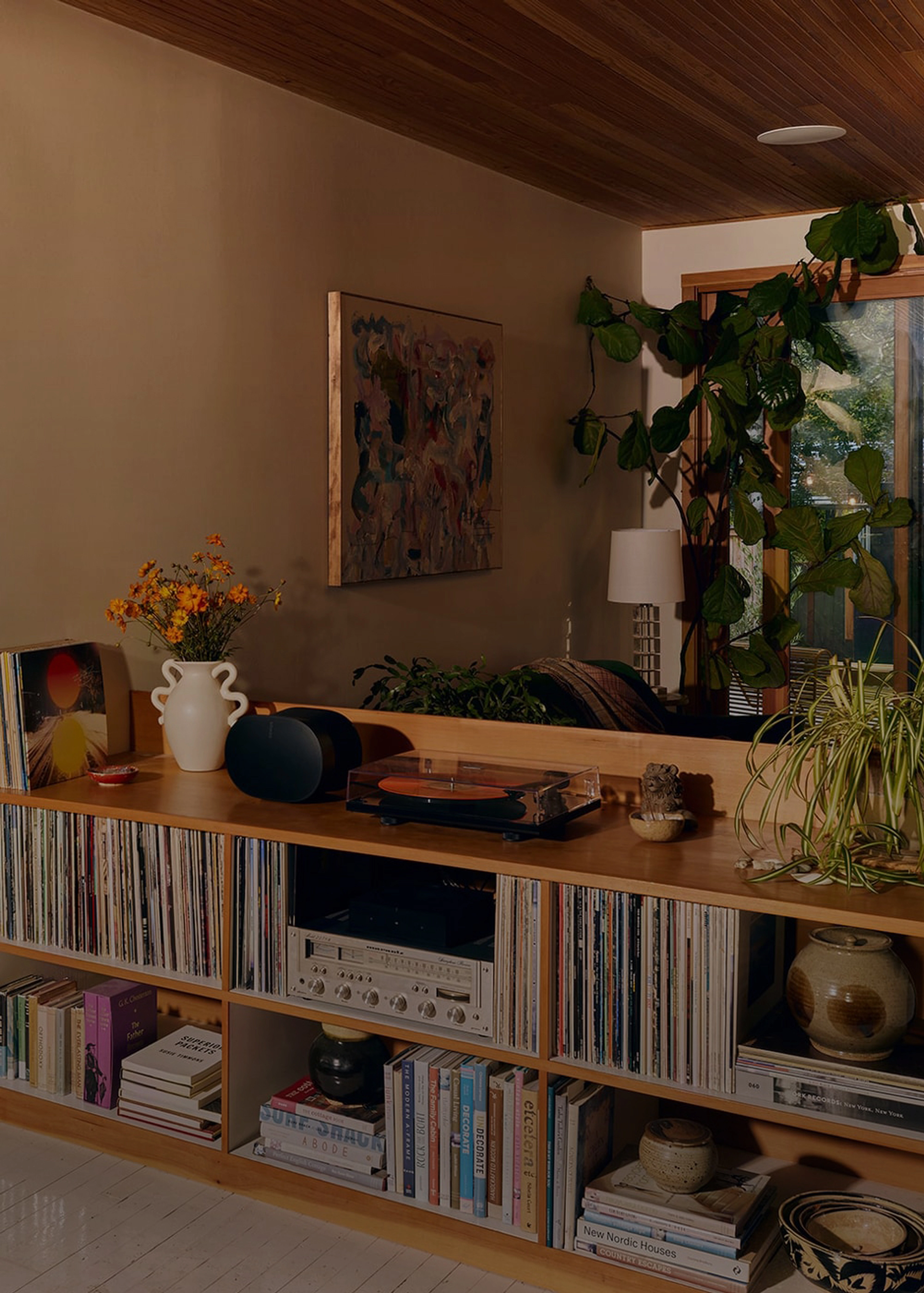 A black Era 300 speaker on top of a console table in a living room