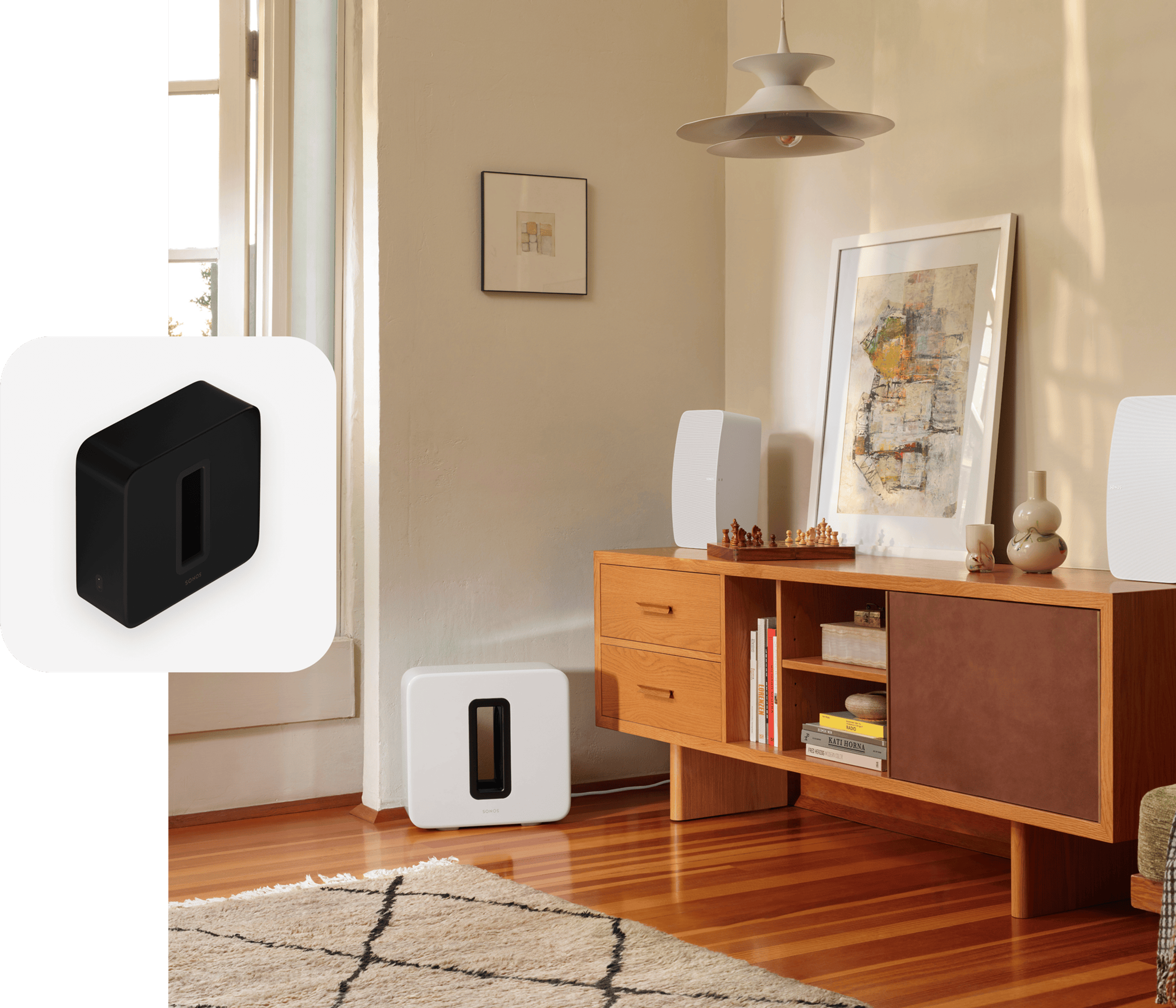 A white Sub (Gen 3) next to a credenza with a pair of white Sonos Fives