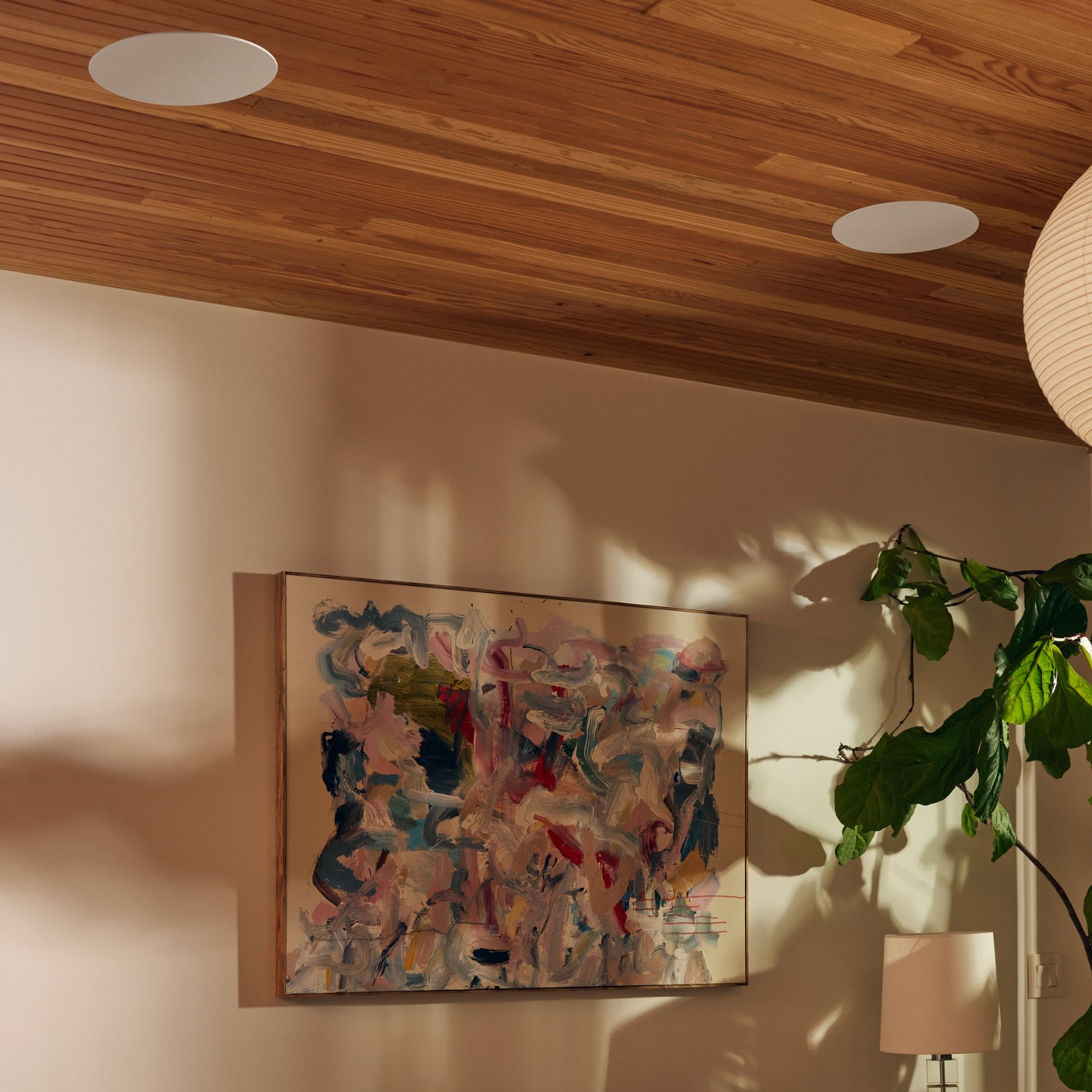 Closeup of in-ceiling speakers by Sonos and Sonance next to a painting
