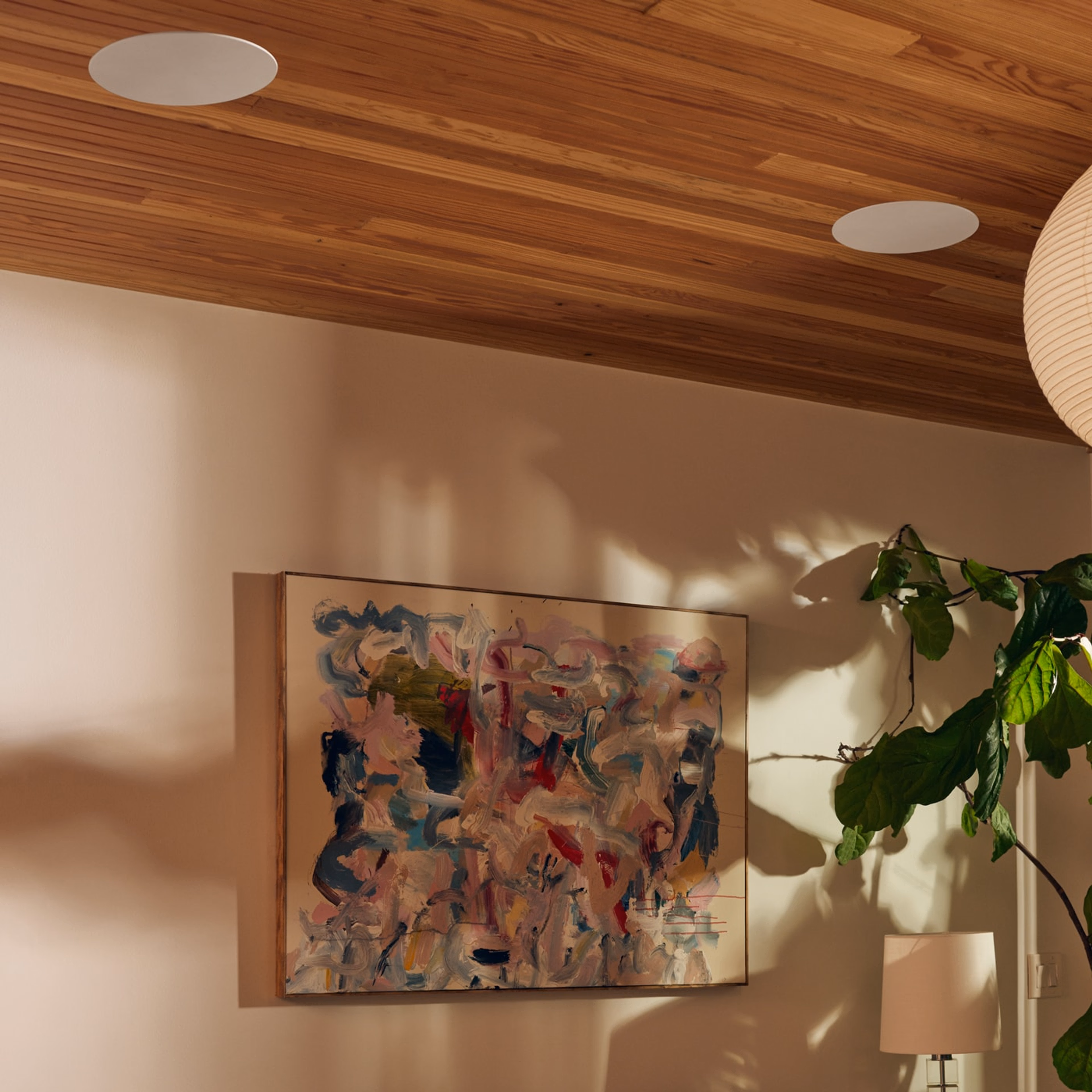 Closeup of in-ceiling speakers by Sonos and Sonance next to a painting