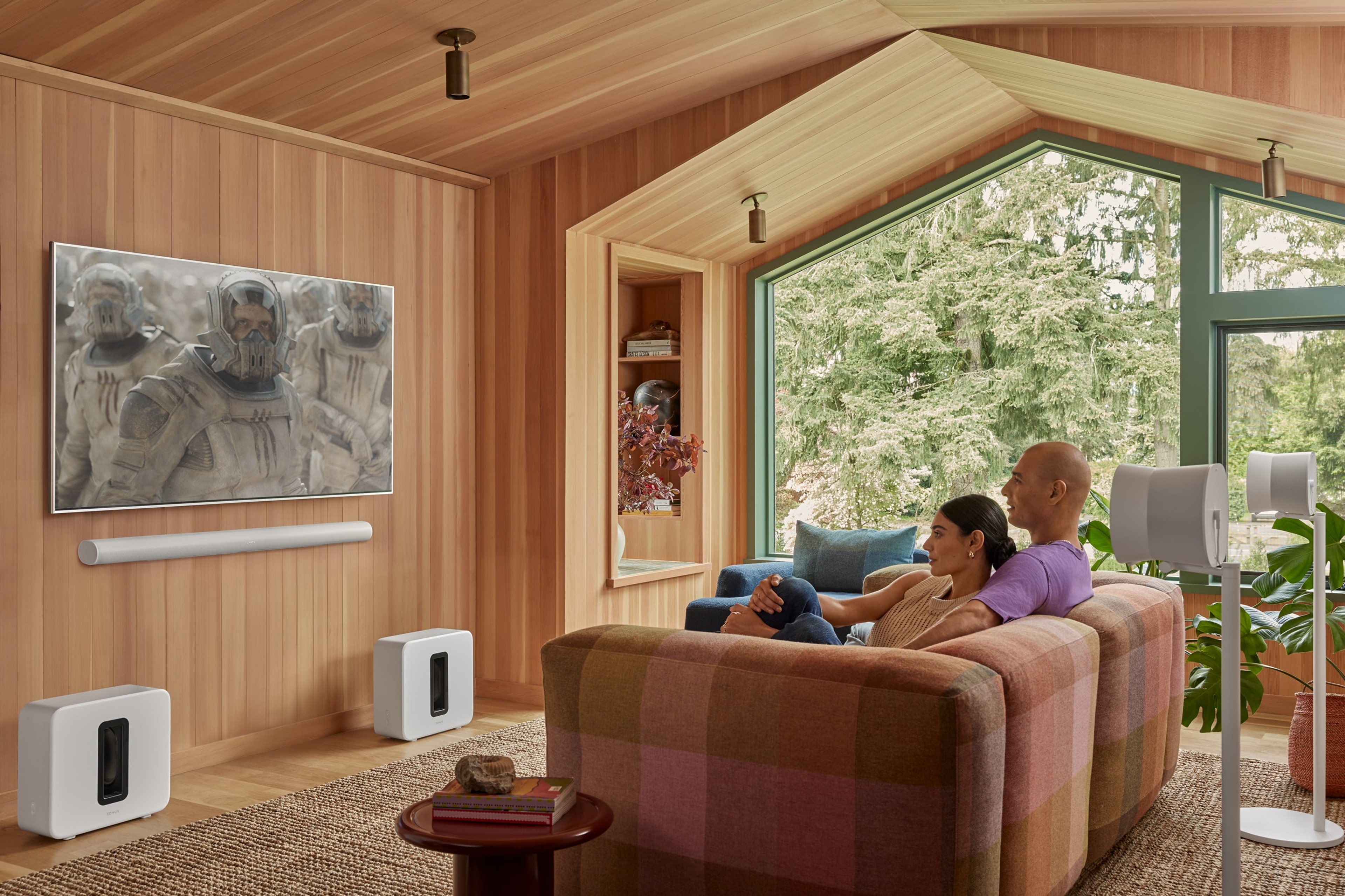 Couple watching TV in the living room with Home Theatre set (Sonos Arc Ultra, Dual Sub 4 and Dual Era 300)