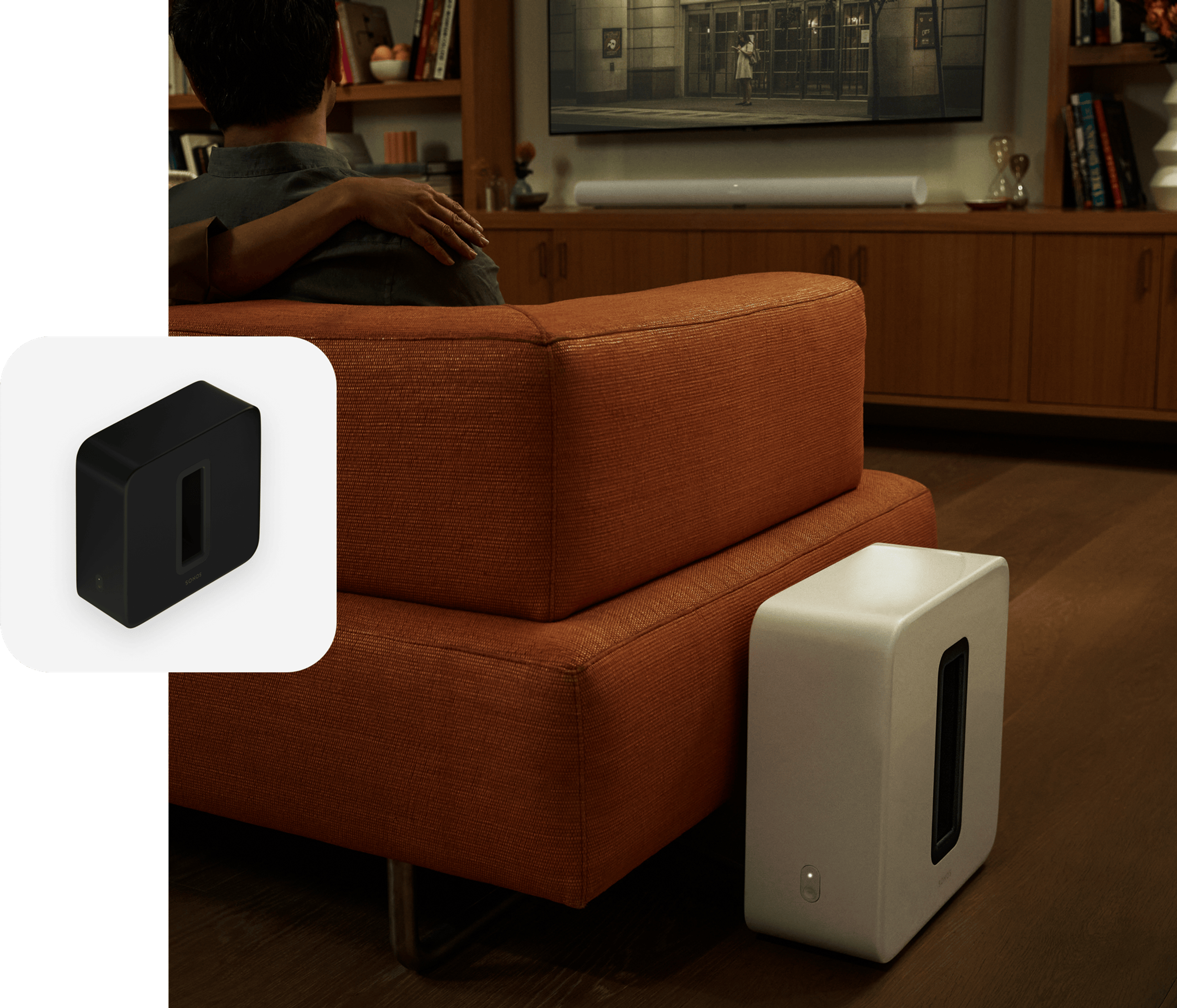 A white Sub (Gen 3) next to an orange couch while a couple watches a movie