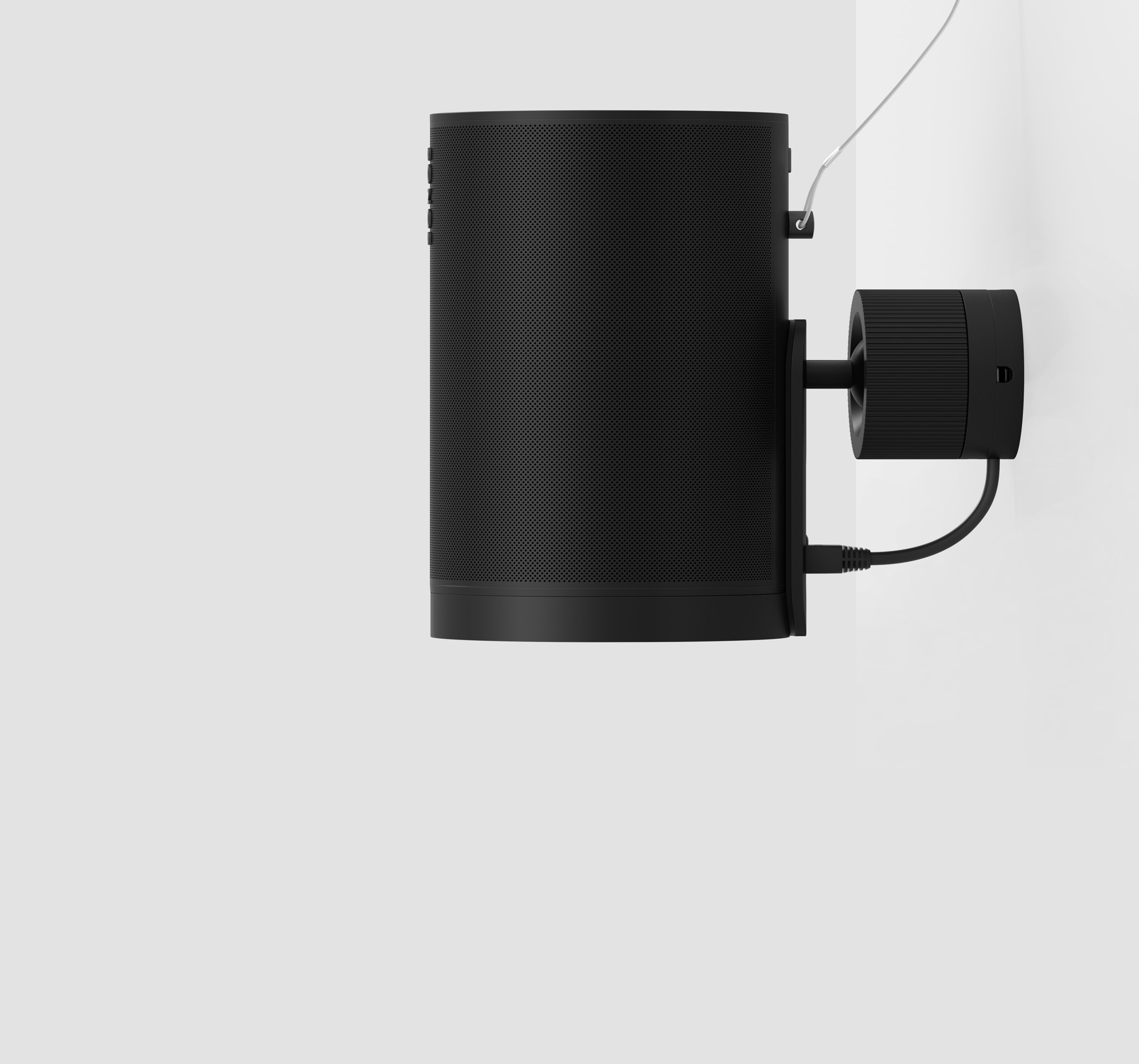A black Era 100 Pro speaker mounted to the wall with a secondary safety attachment