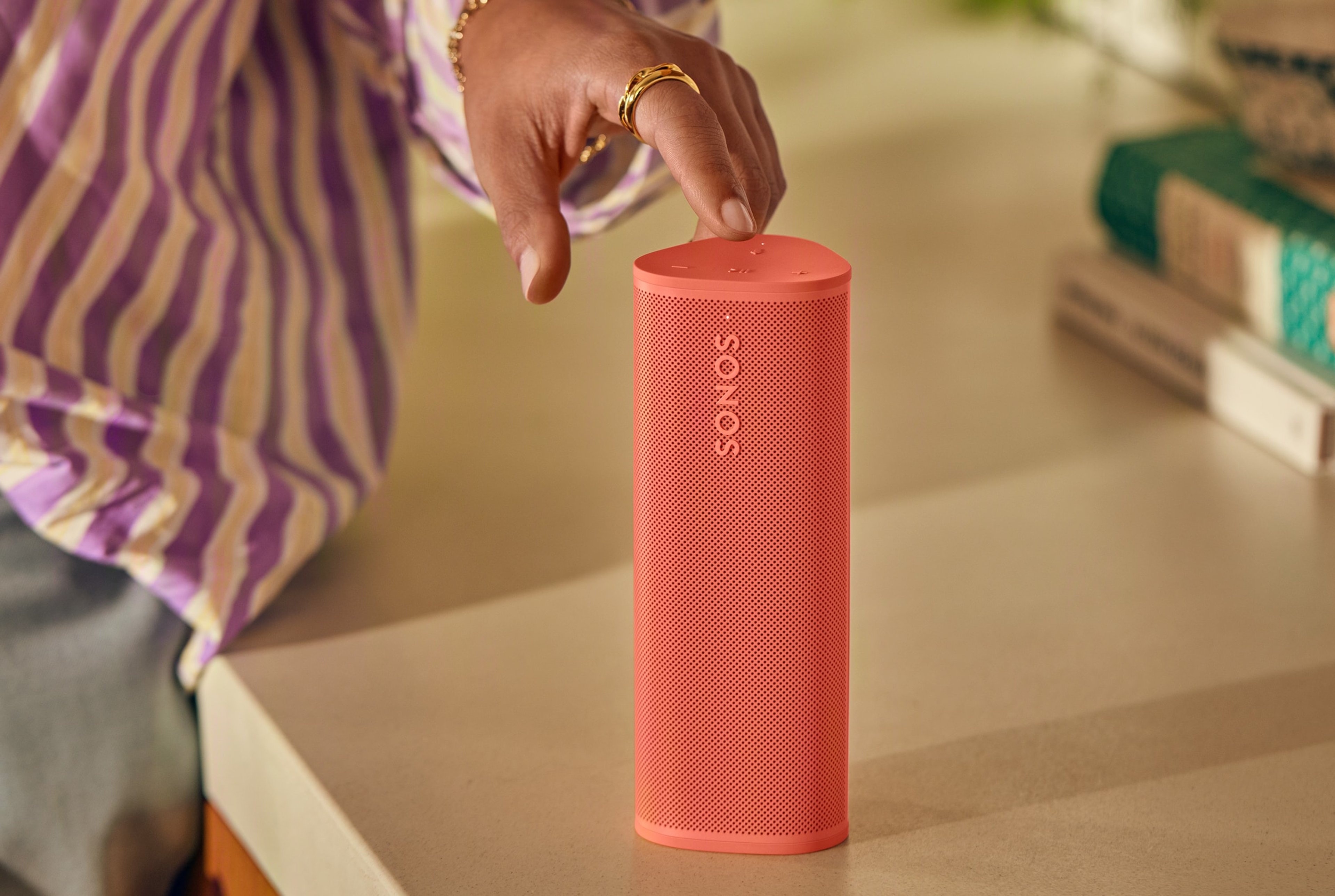 Woman's hand using the touch controls on a Sunset Roam 2