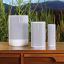 A white Sonos Move 2, a white Sonos Play, and a white Sonos Roam 2