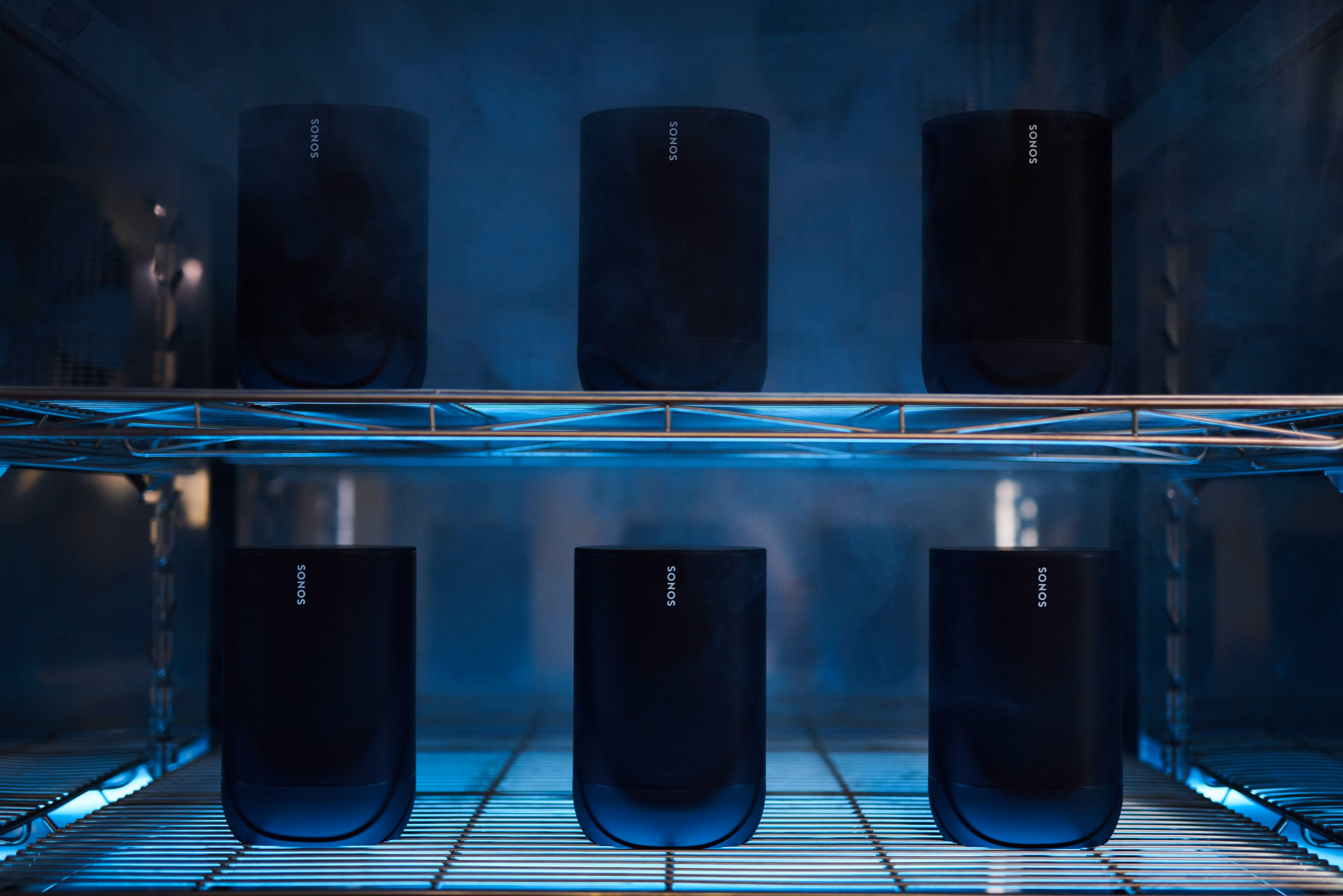 Six Sonos Move speakers on shelves in the hardware lab being temperature tested