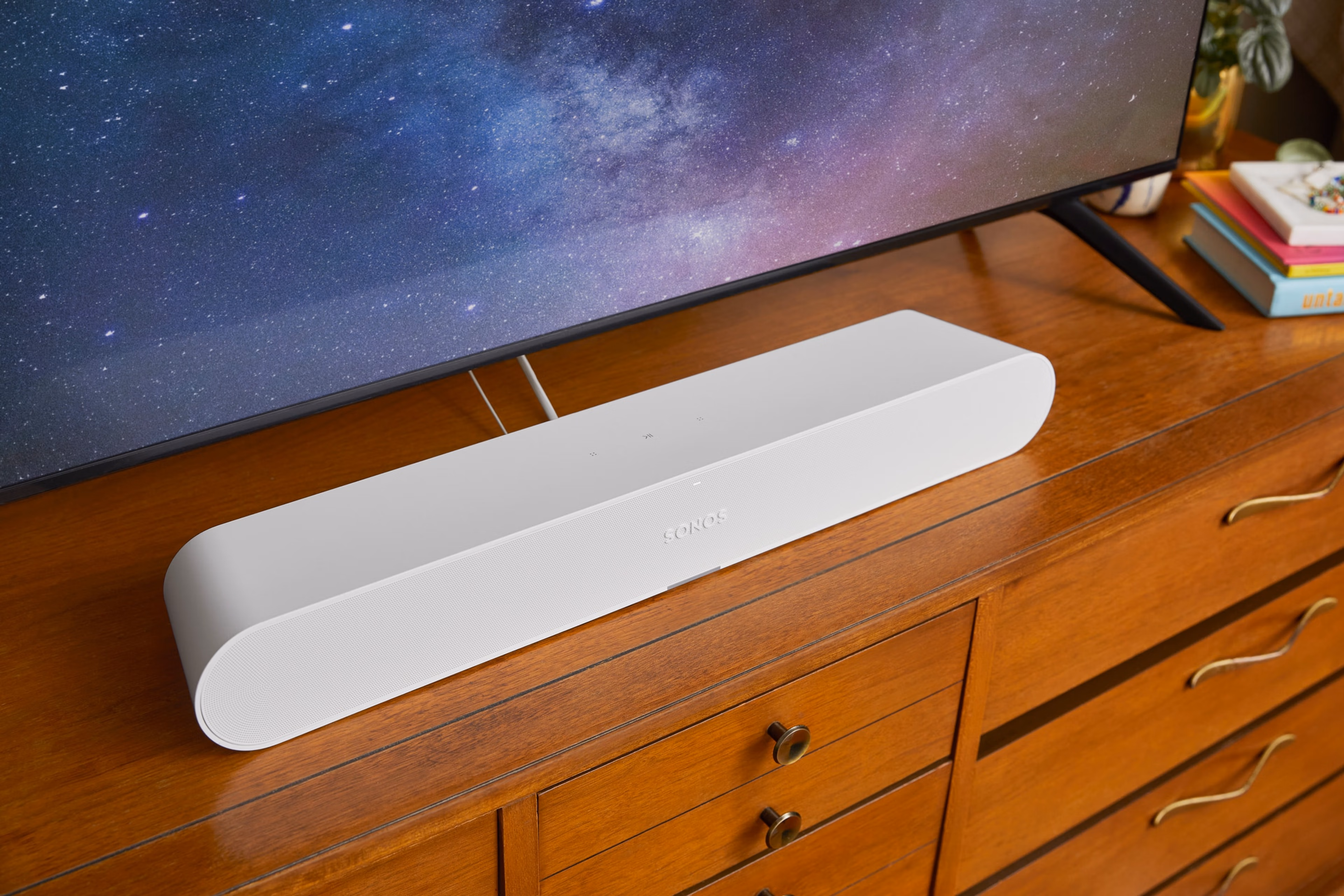 White Sonos Ray on top of a tv stand