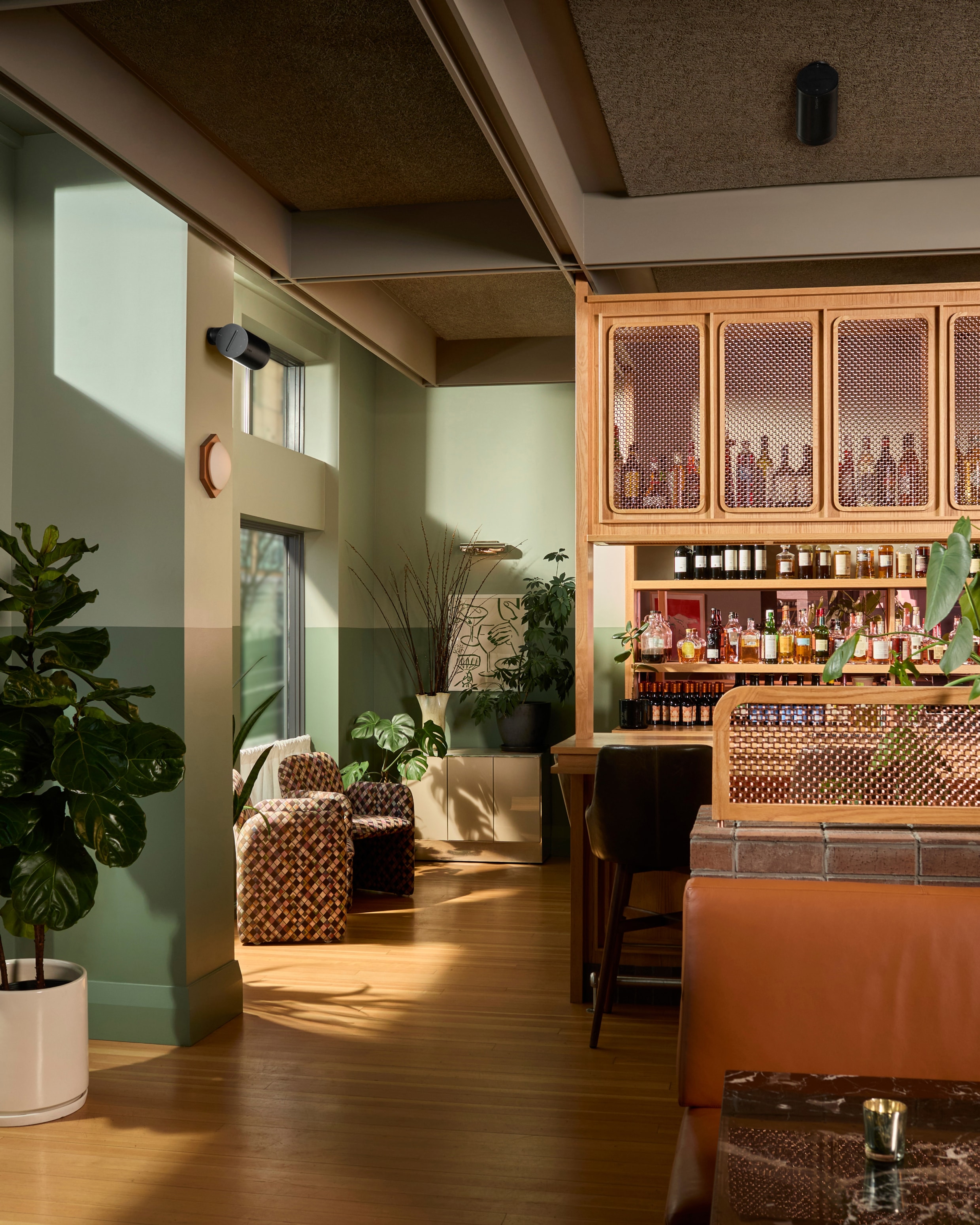 Interior of a restaurant bar with wall-mounted Era 100 Pro speakers