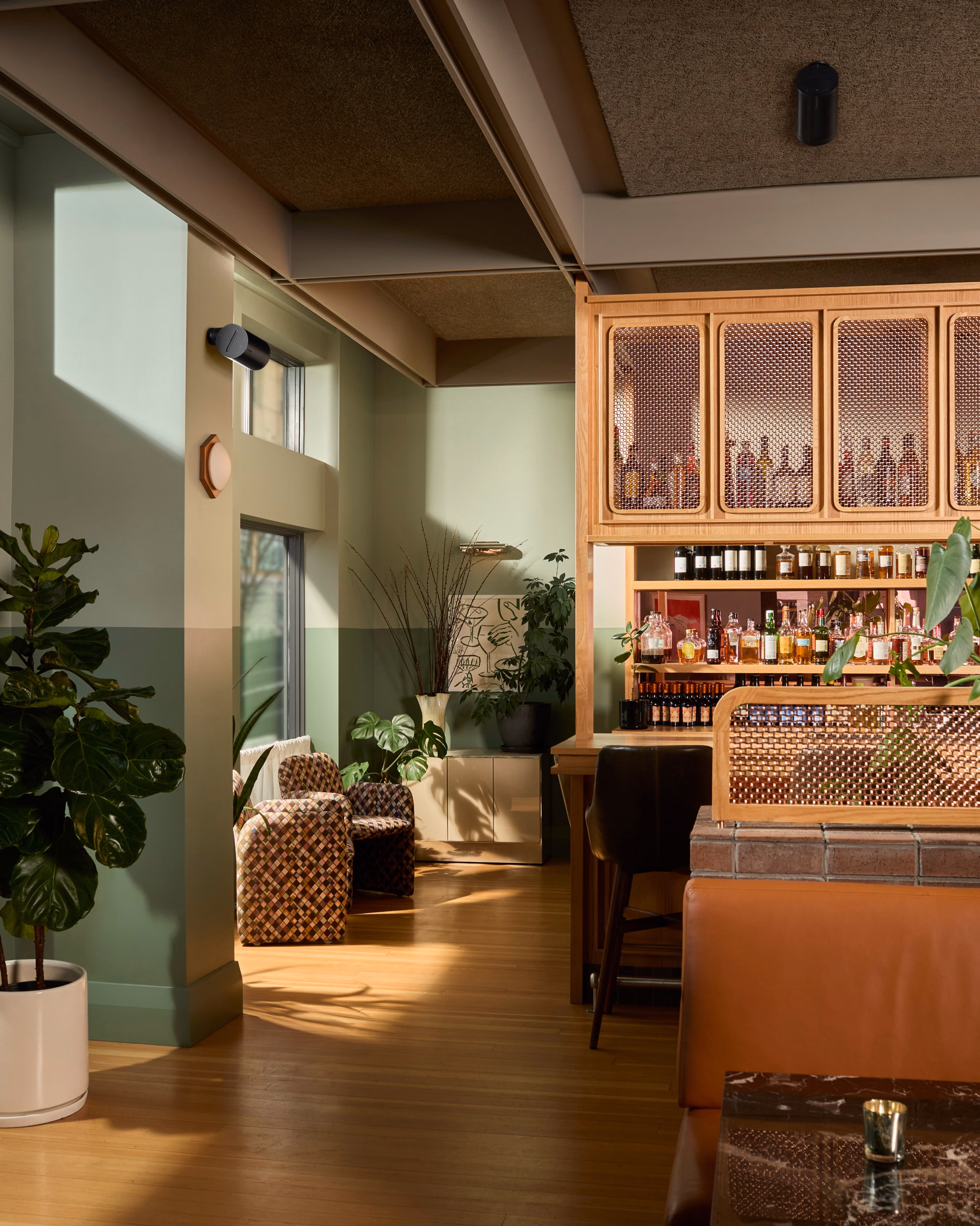 Interior of a restaurant bar with wall-mounted Era 100 Pro speakers