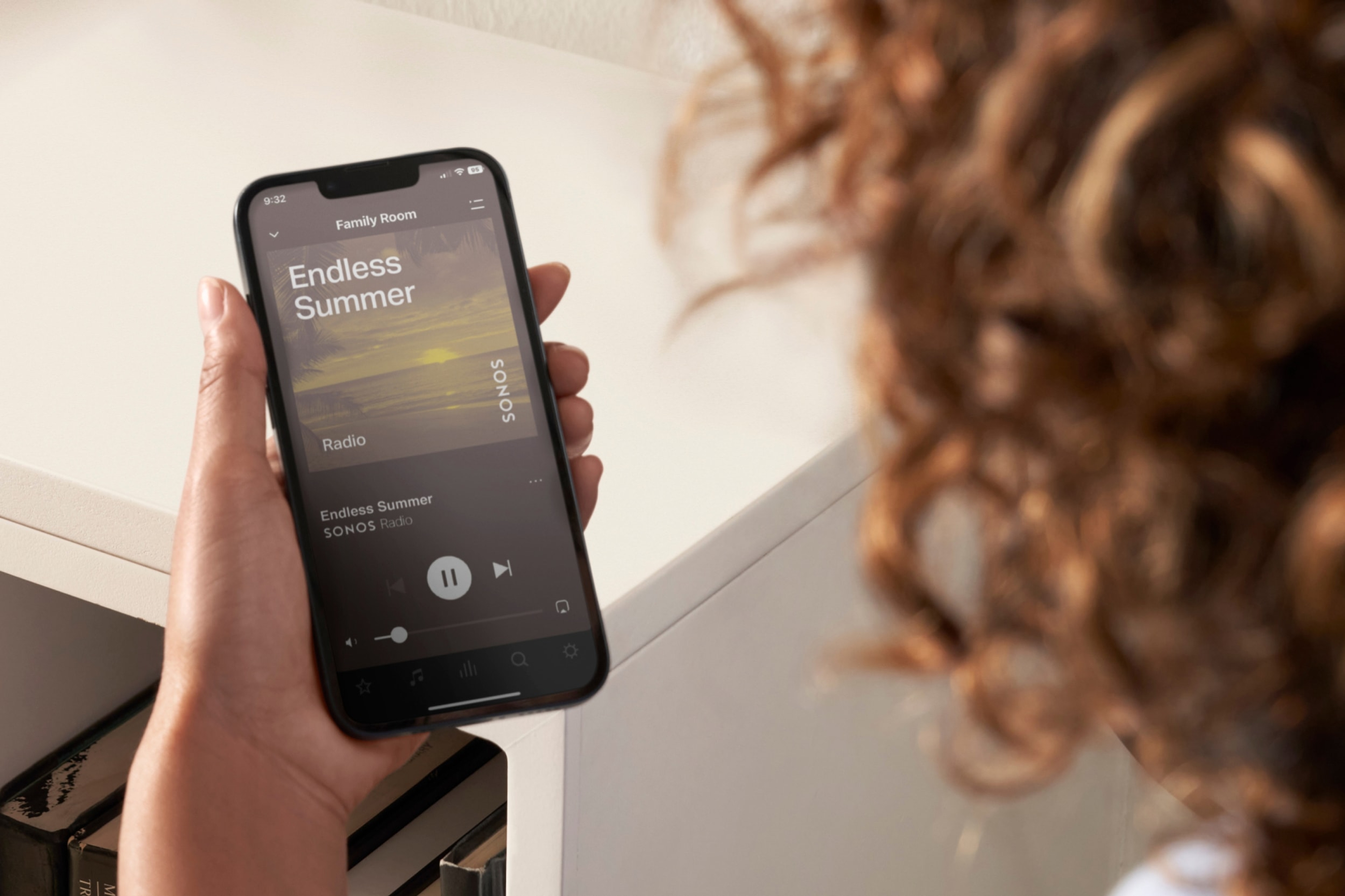 A closeup image of a user's phone as they use the Sonos app to control their Sonos system