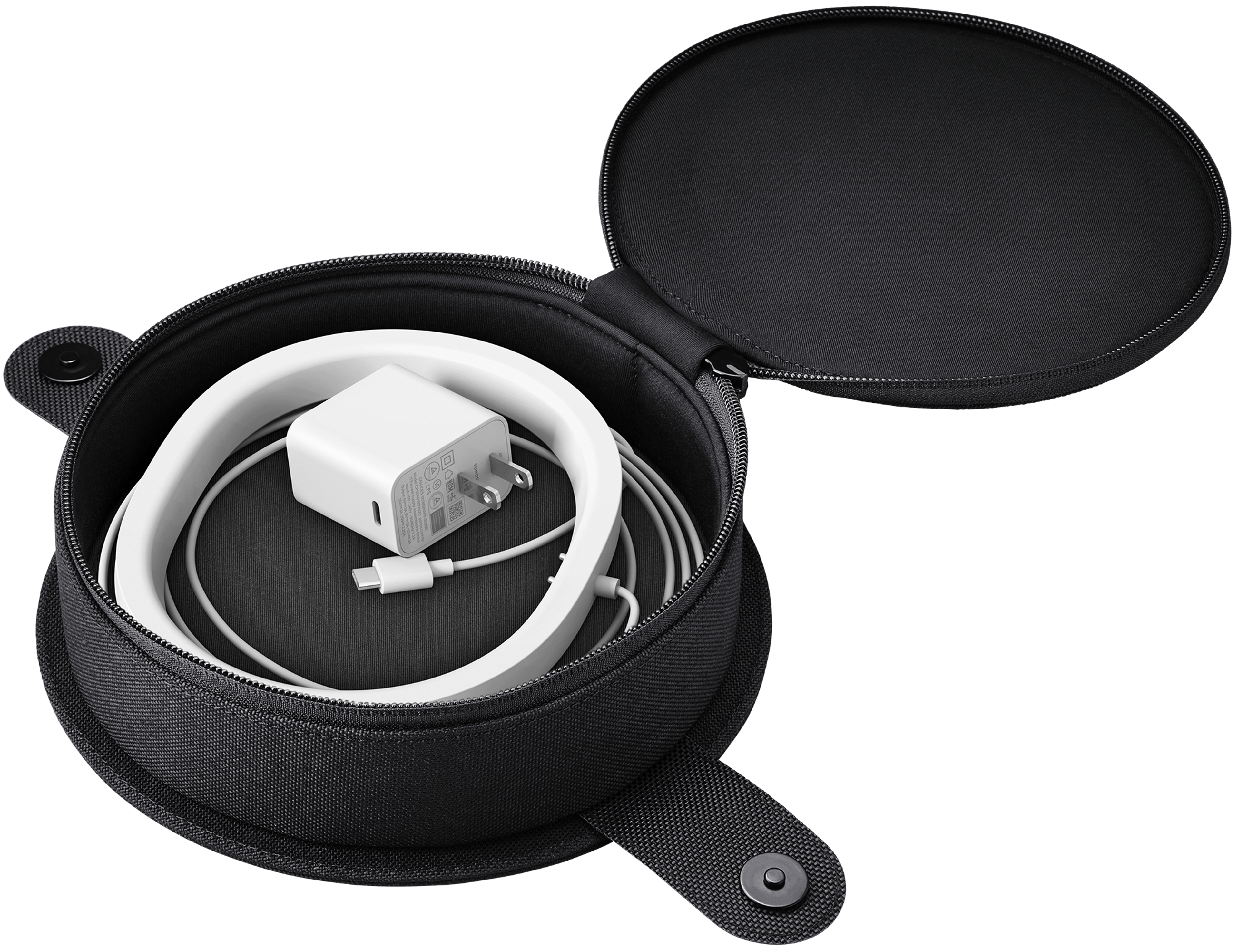 Image of the open charging base compartment of the Move Travel Bag with a white Move charging base inside