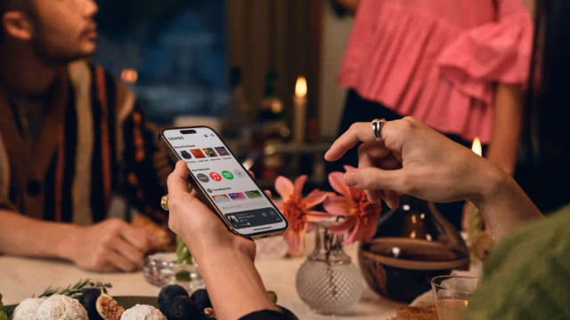 Person using the Sonos app on a smartphone