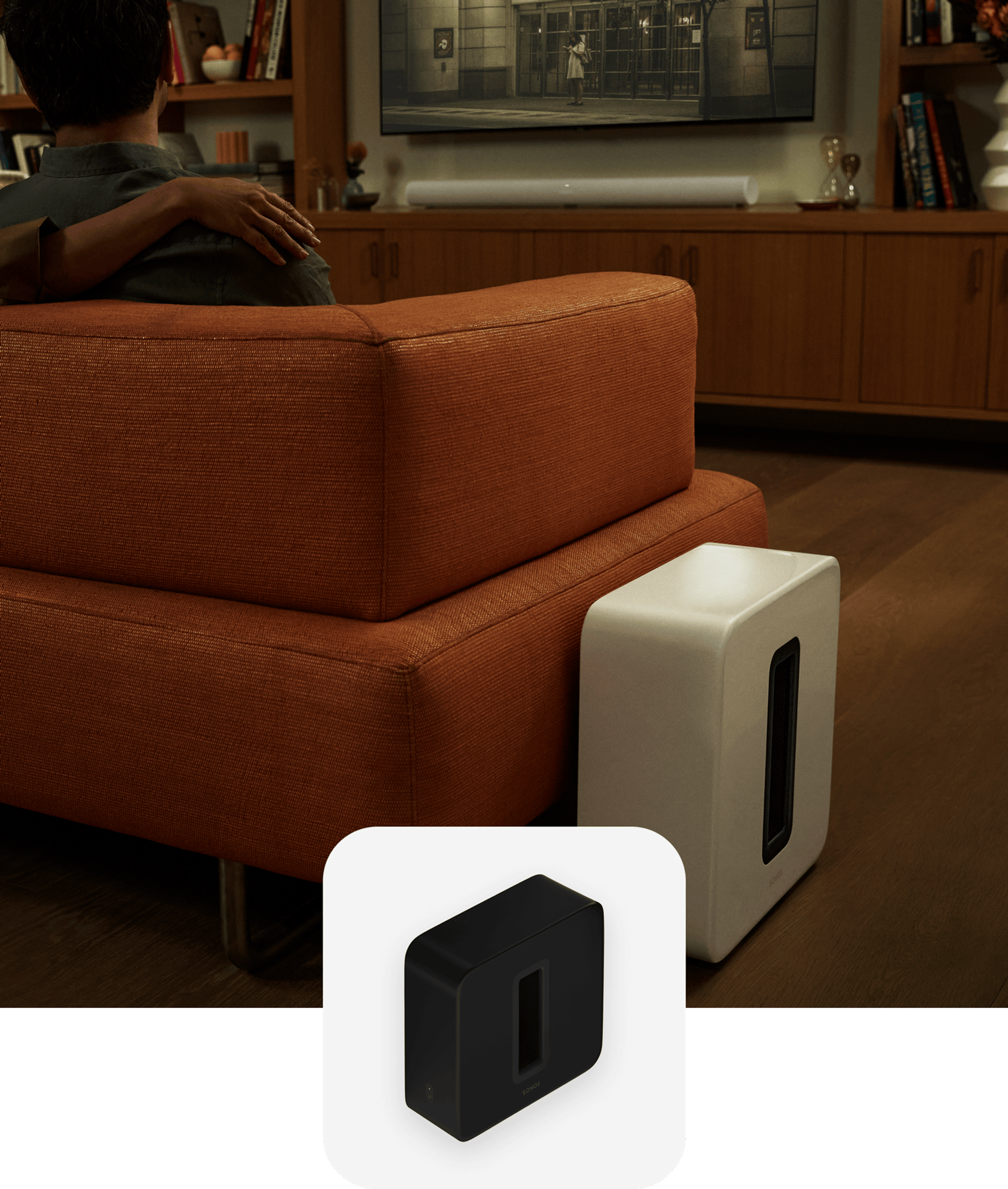 A white Sub (Gen 3) next to an orange couch while a couple watches a movie