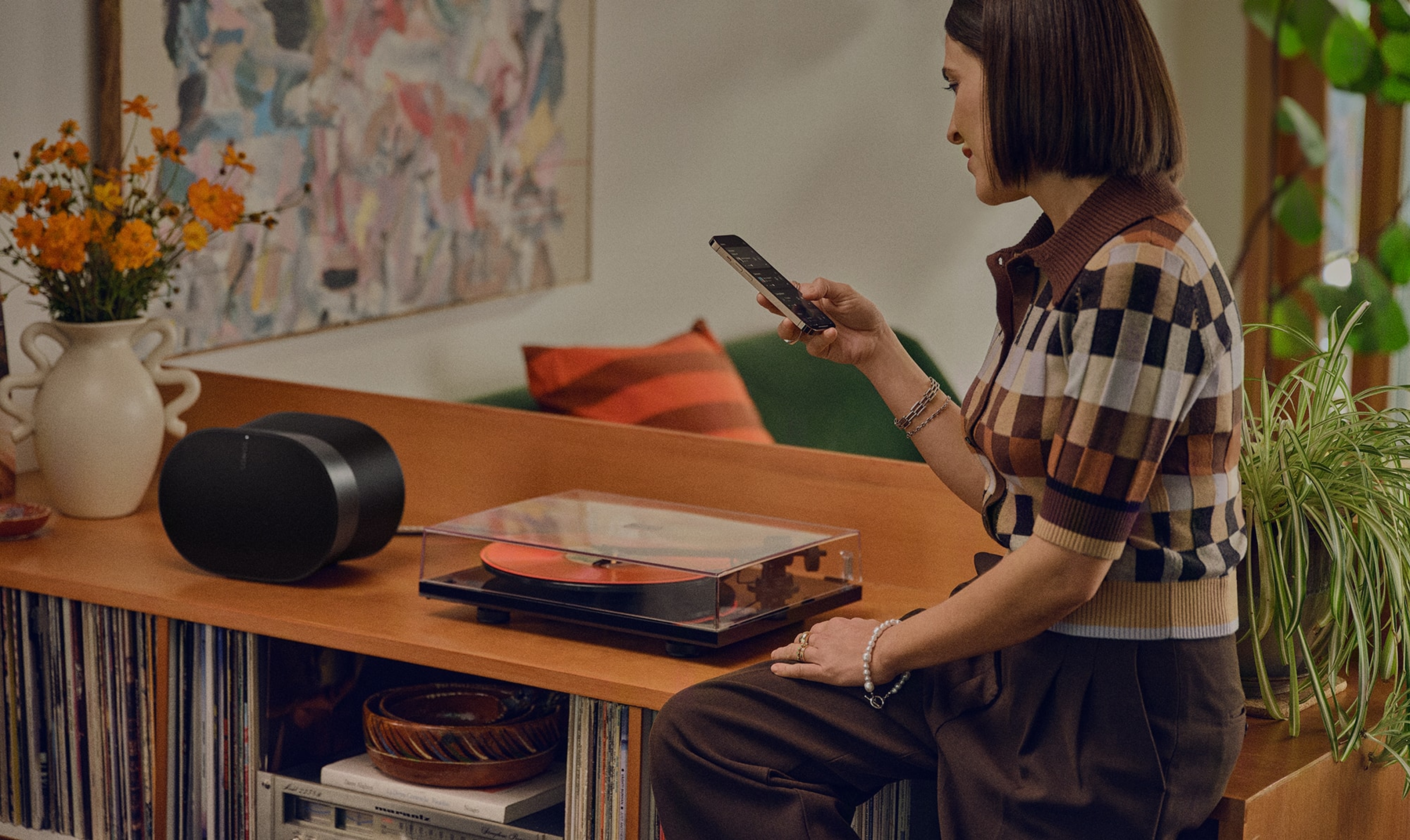 Woman controlling her black Era 300 with her smartphone