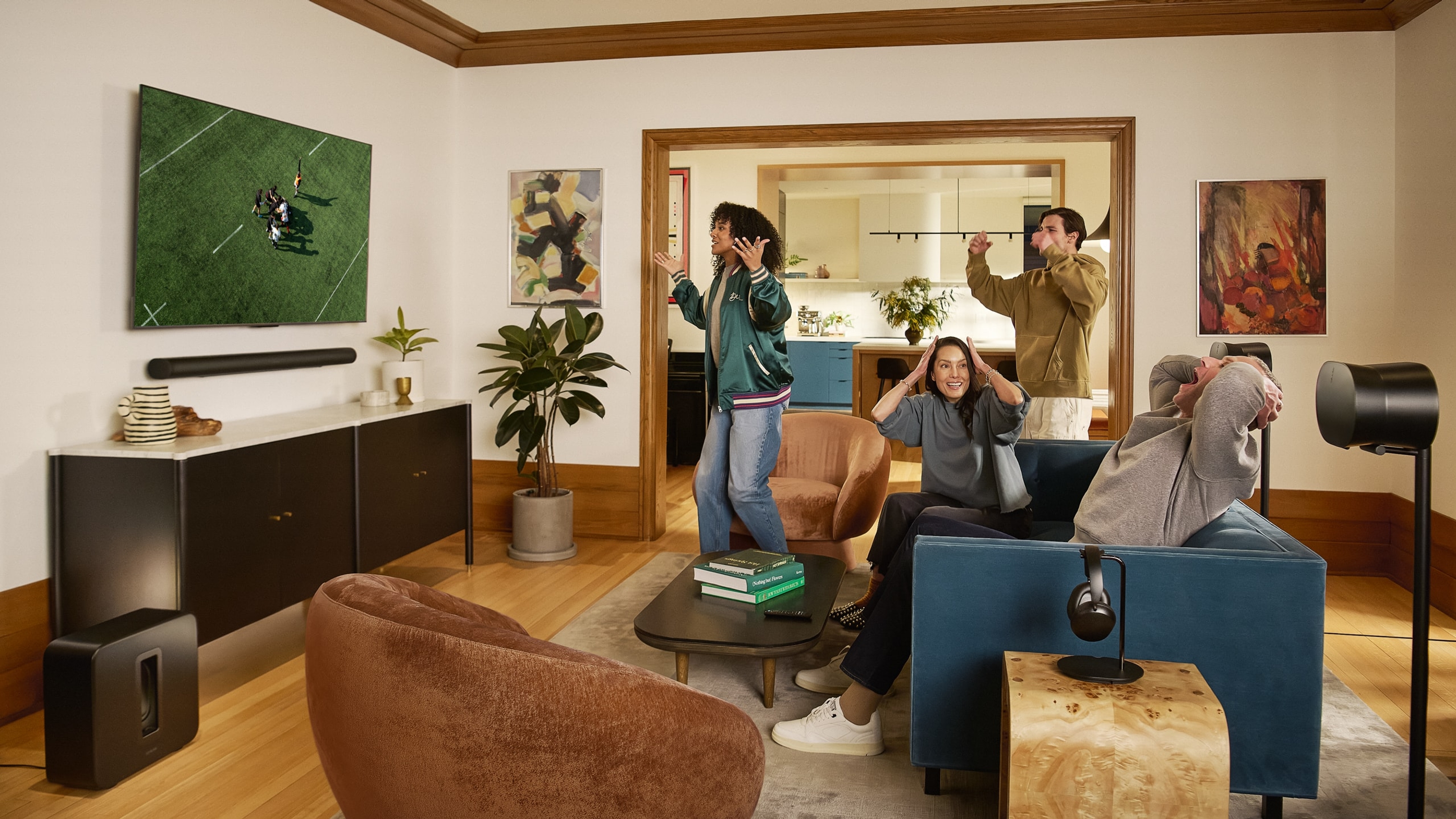 Group of friends watching a rugby match on TV with a Sonos Arc Ultra home theater setup