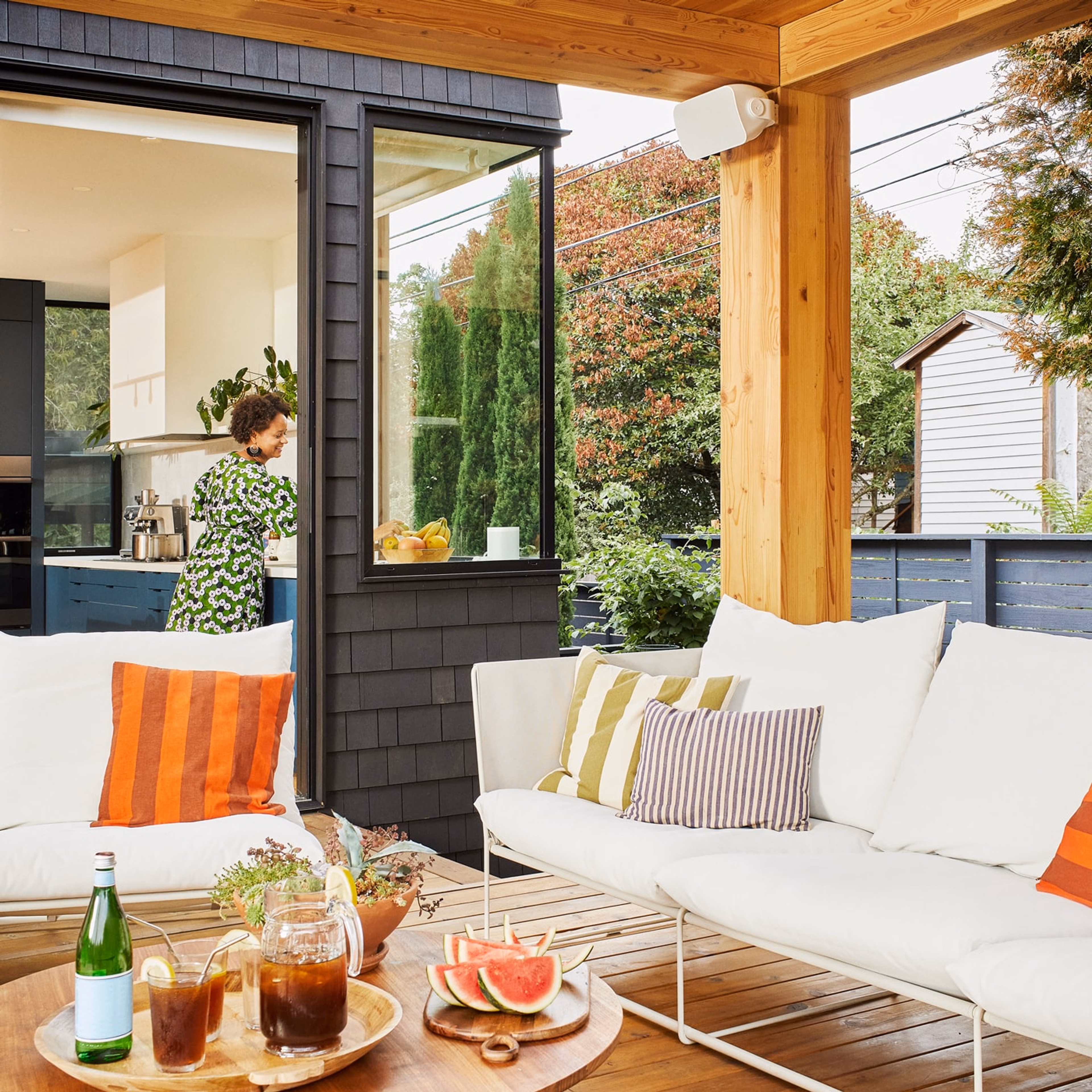 Drinks on the patio with a white outdoor speaker by Sonos and Sonance installed