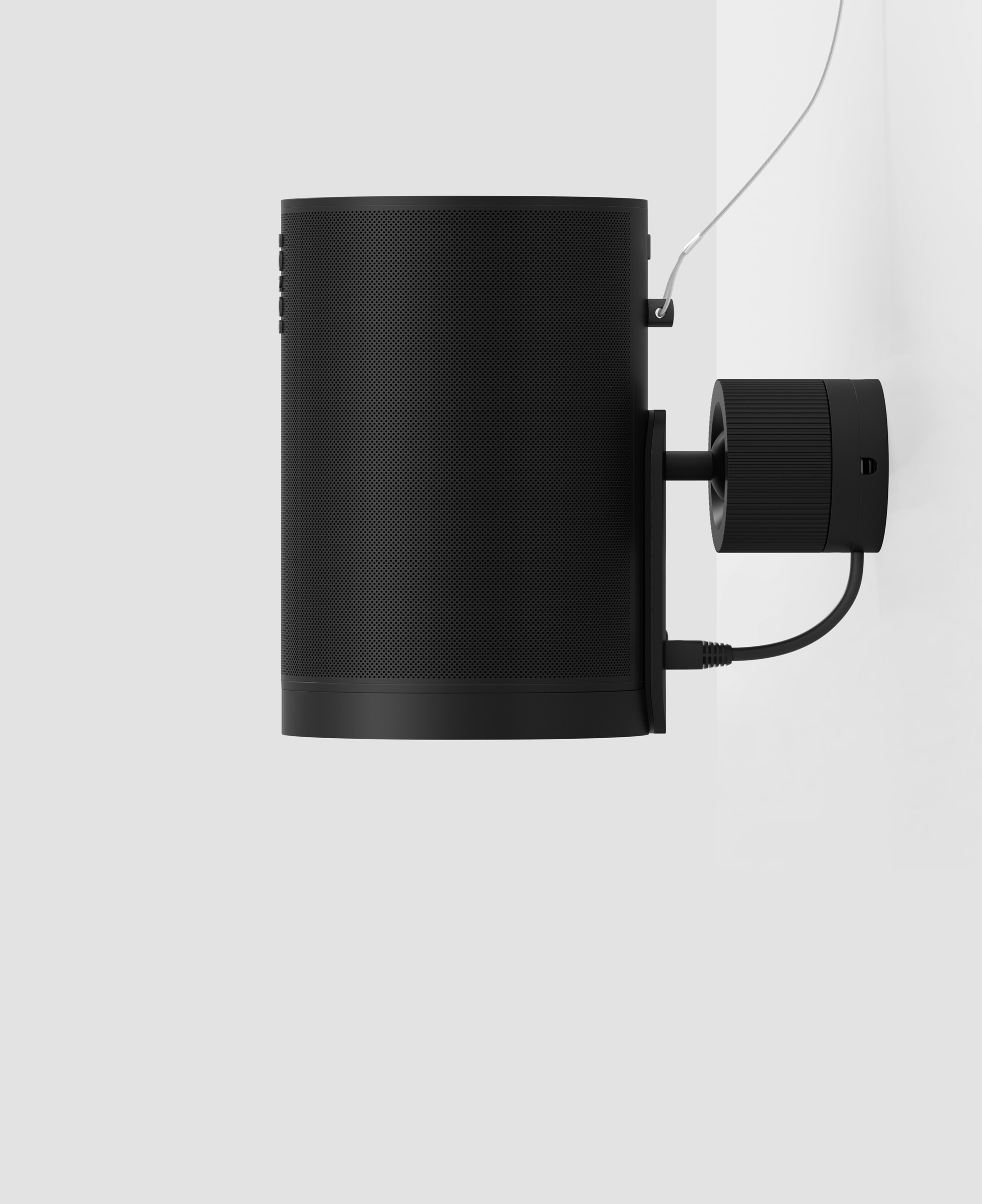 A black Era 100 Pro speaker mounted to the wall with a secondary safety attachment
