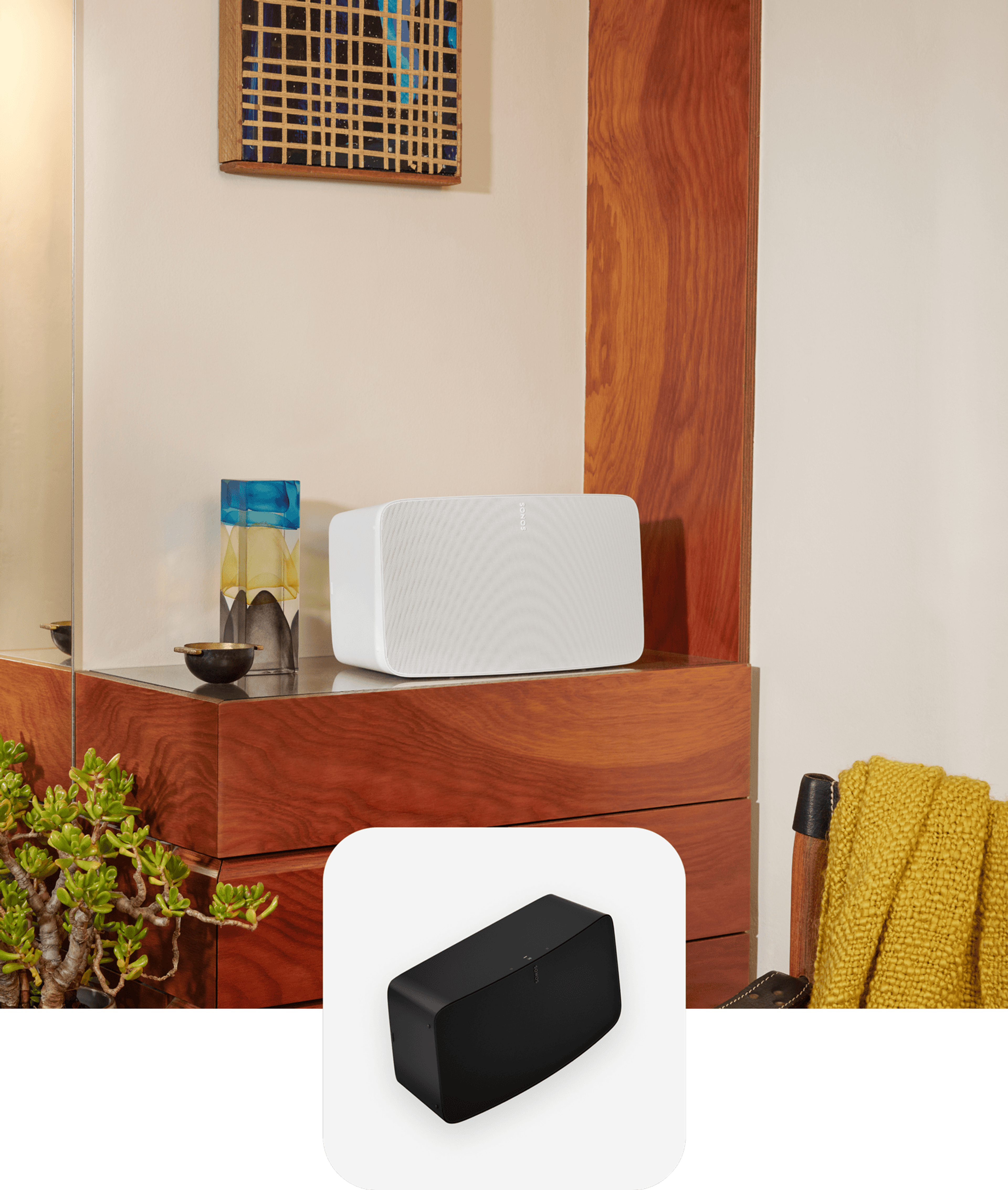A white Sonos Five speaker sitting on a bedroom dresser