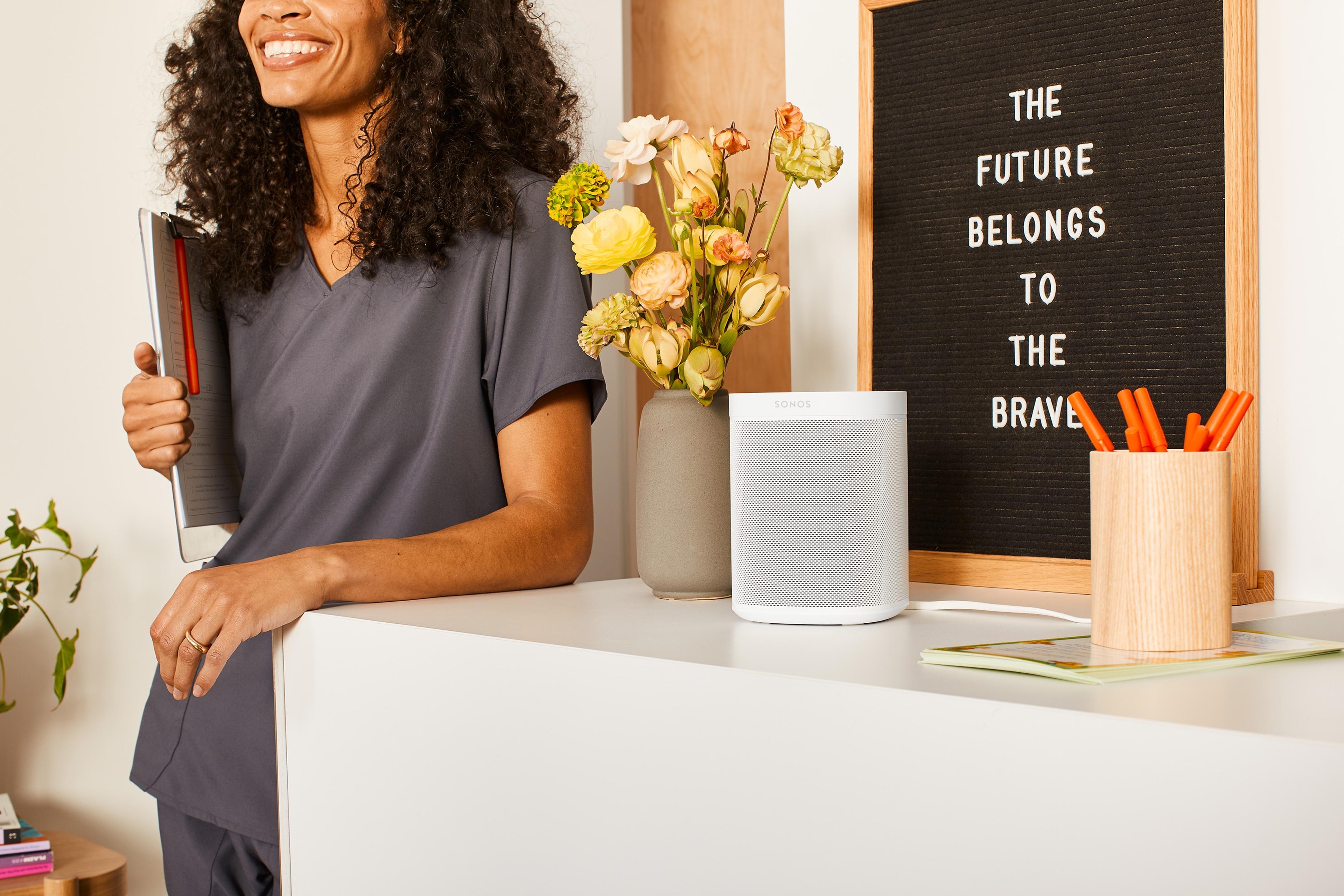 Sonos One white next to a flower vase