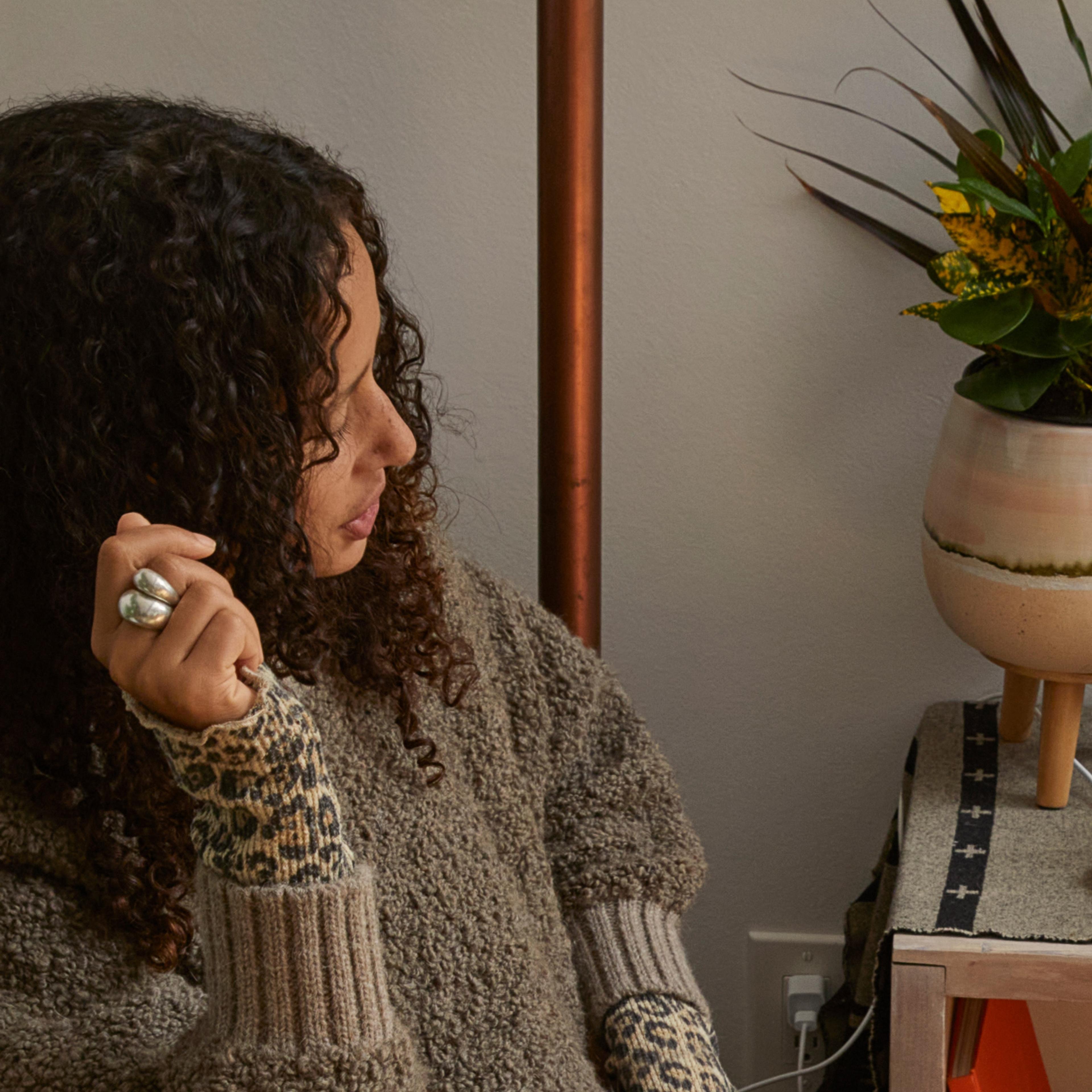 Woman using voice commands with Sonos speaker