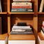 Sonos Amp on top of books in a bookcase