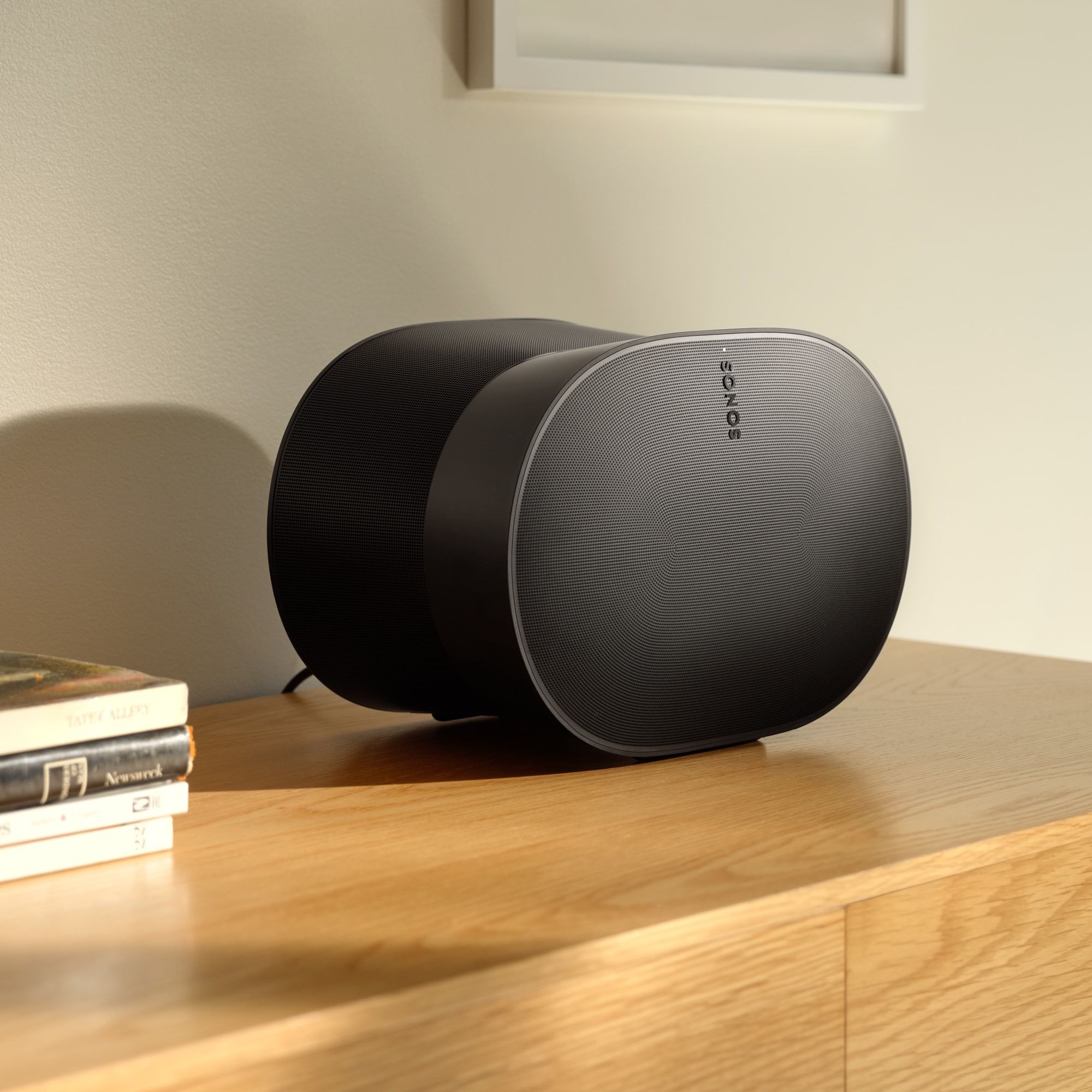 Sonos Era 300 v přirozeném světle u okna — atmosférická scéna ukazující jemnou siluetu a hladký matný povrch