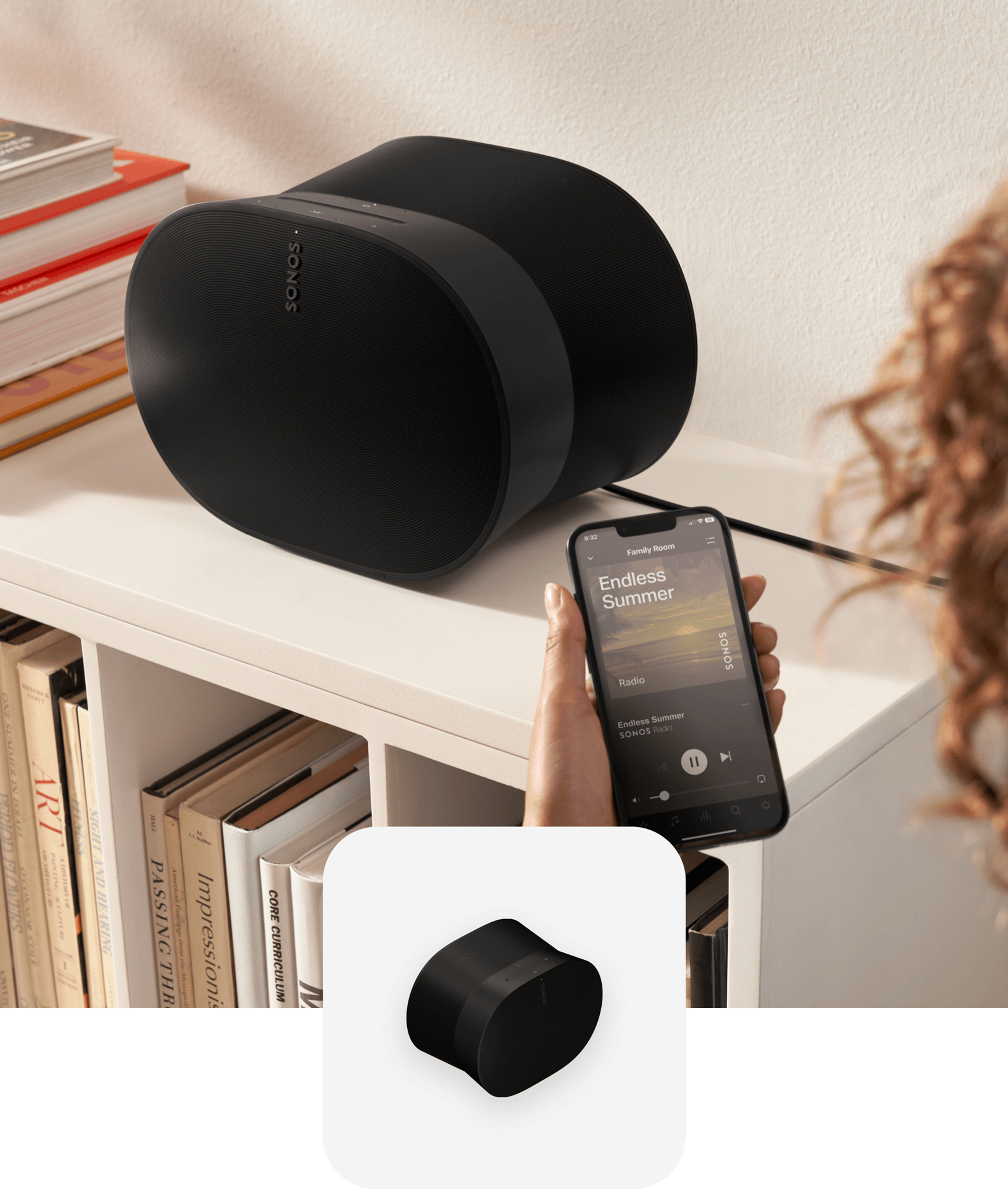 User with phone using the Sonos App to control a black Era 300 speaker